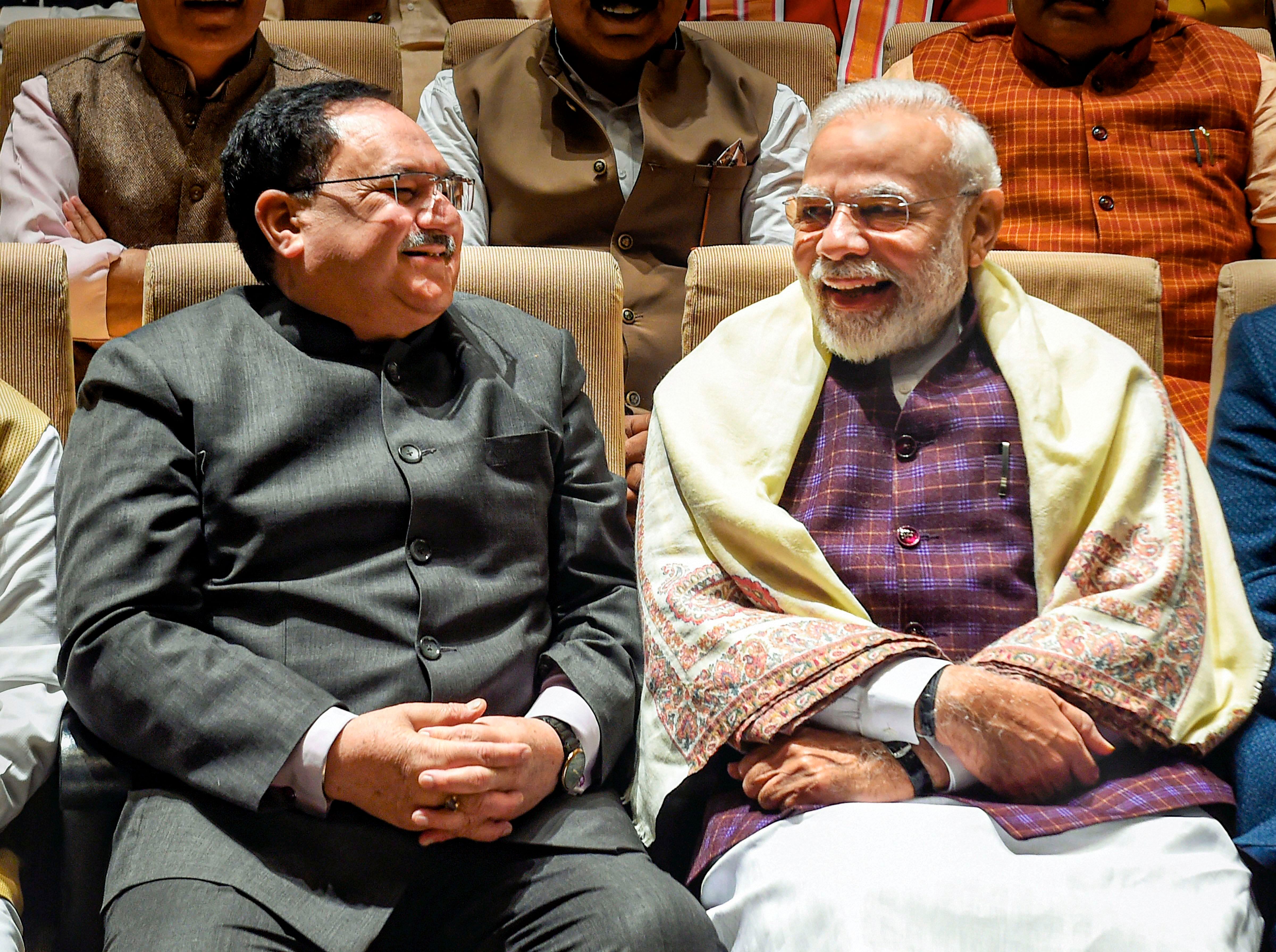 Prime Minister Narendra Modi (R) and BJP National President JP Nadda (L) share a light moment during the BJP Parliamentary Party meeting at Parliament House, in New Delhi. (Credit: PTI)