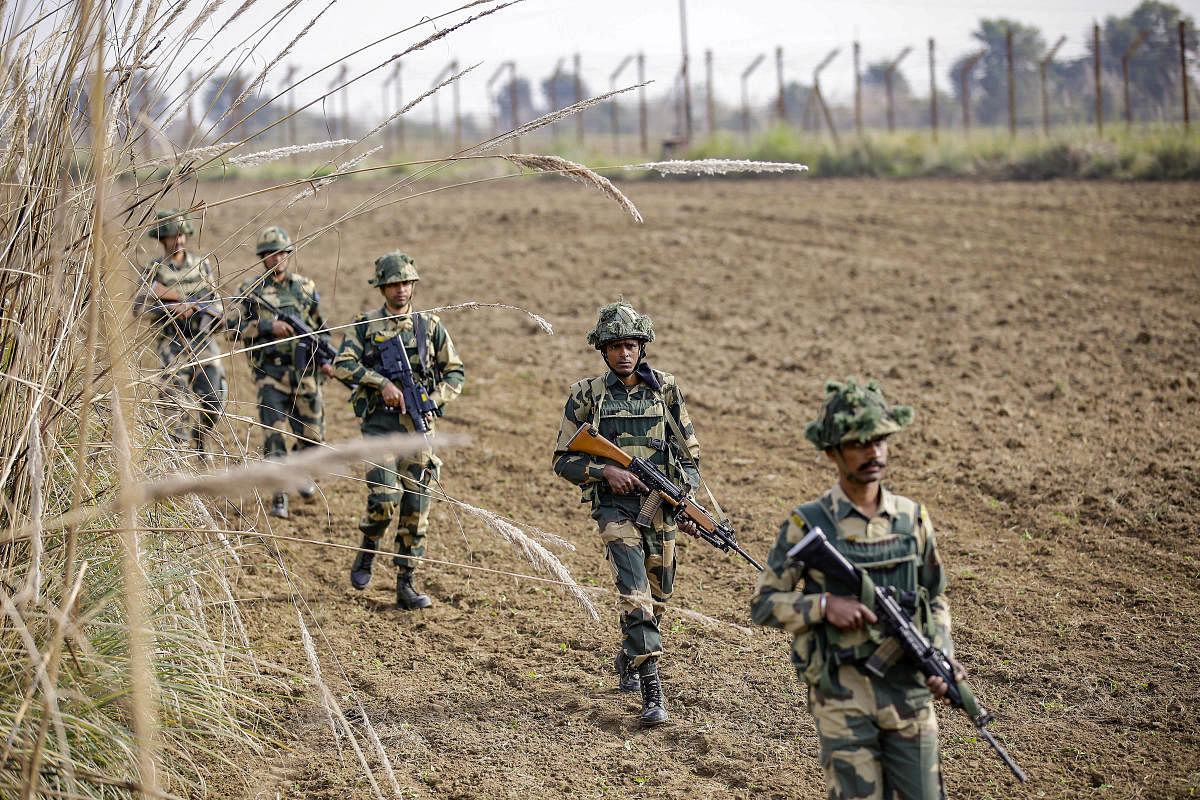 BSF jawans provide security cover to the bullet proof tractors (PTI Photo)