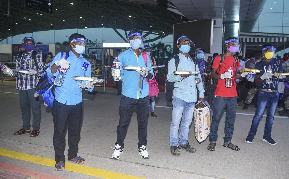 Migrants wearing face shield leave from Birsa Munda International airport after they arrive by a special flight from Andaman, during the ongoing COVID-19 lockdown, in Ranchi (PTI Photo)
