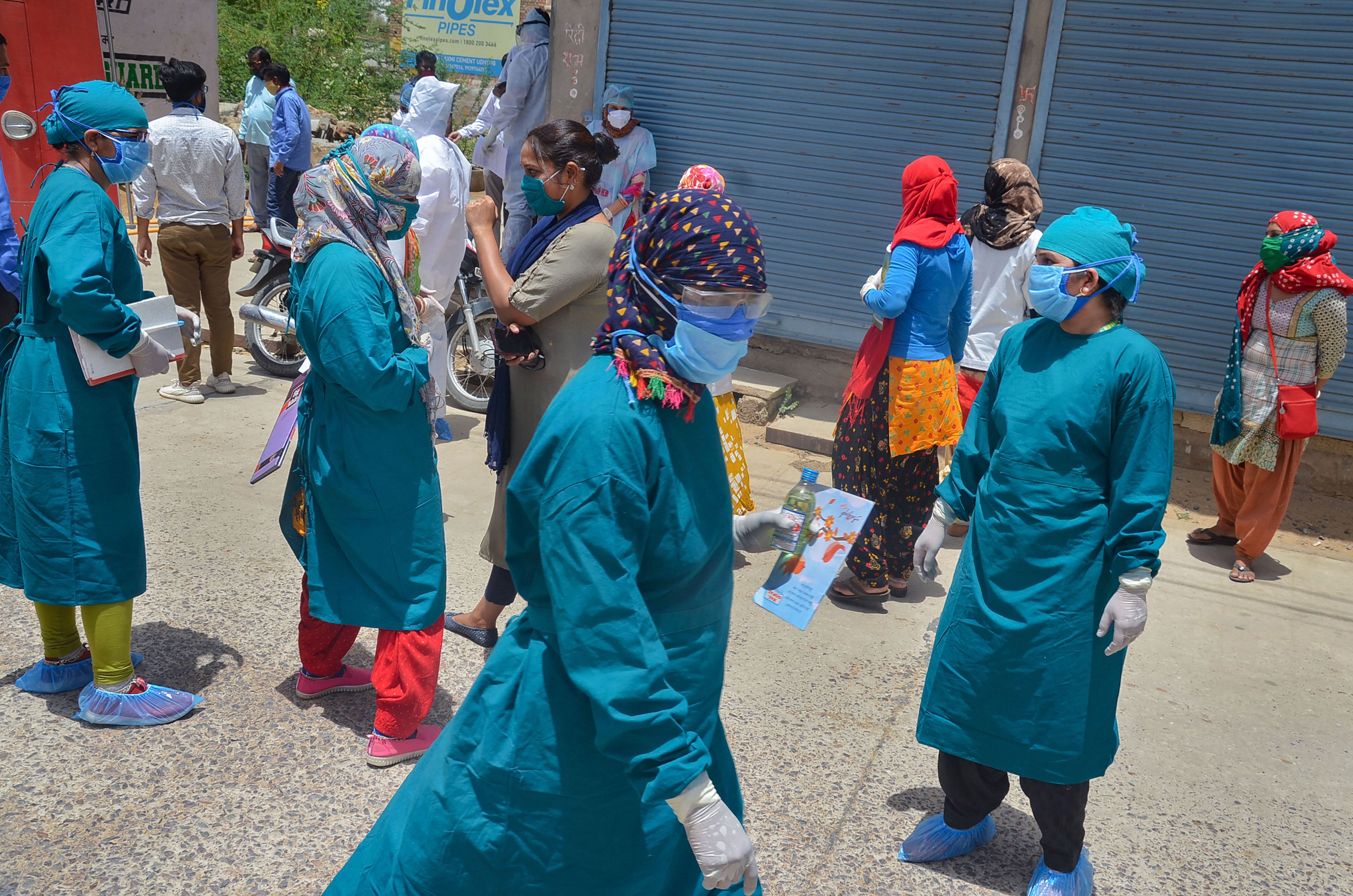 Medics prepare to conduct tests at a locality after emergence of a COVID-19 positive patient, during the ongoing COVID-19 nationwide lockdown. (PTI Photo)