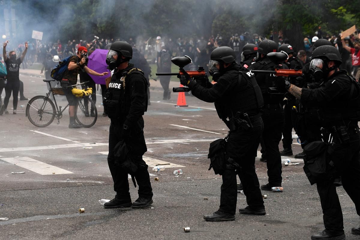 Police fire pepper spray and pepper balls toward protesters during a demonstration in Denver, Colorado, over the death of George Floyd, an unarmed black man who died while while being arrested and pinned to the ground by the knee of a Minneapolis police officer. AFP