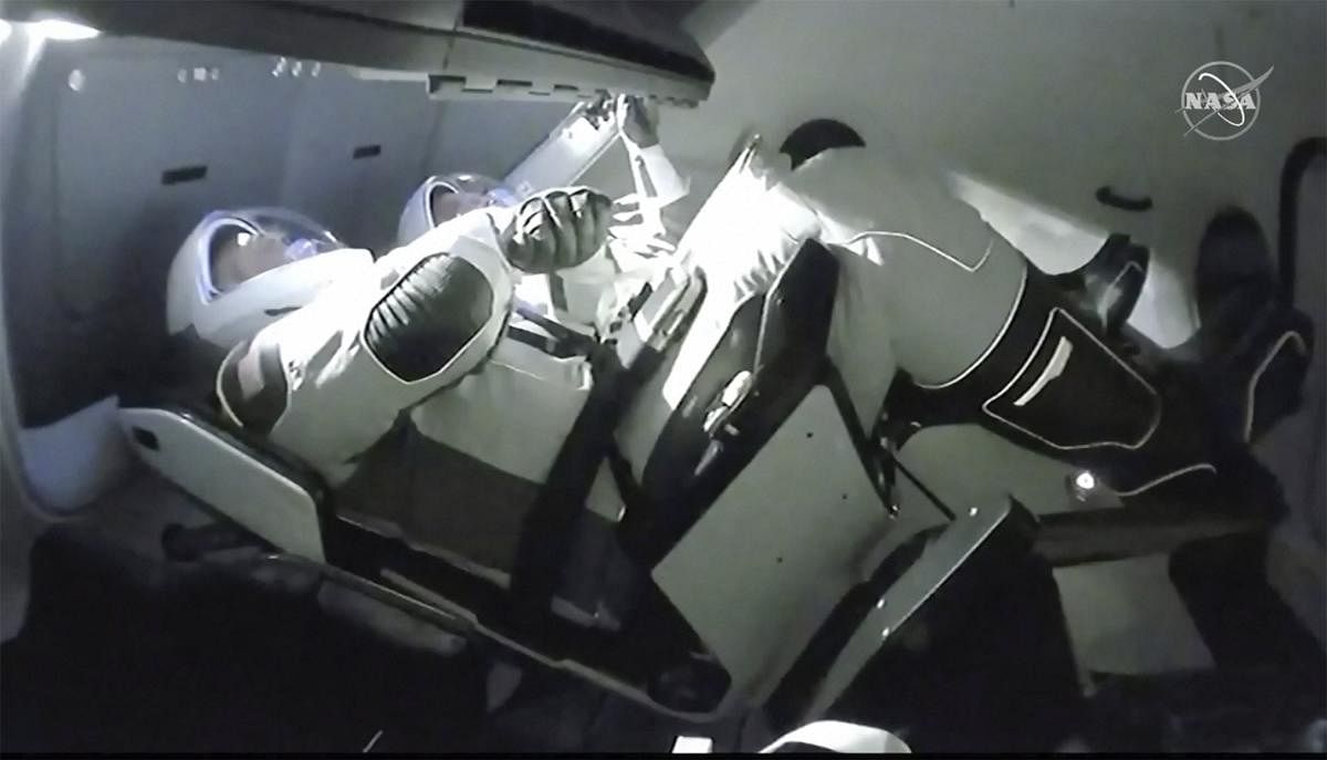 In this image taken from NASA TV video, the SpaceX Dragon crew capsule, with NASA astronauts Doug Hurley, left, and Robert Behnken aboard docks with the International Space Station Sunday, May 31, 2020. It was the first time a privately built and owned spacecraft carried astronauts to the orbiting lab in its nearly 20 years. (PTI)