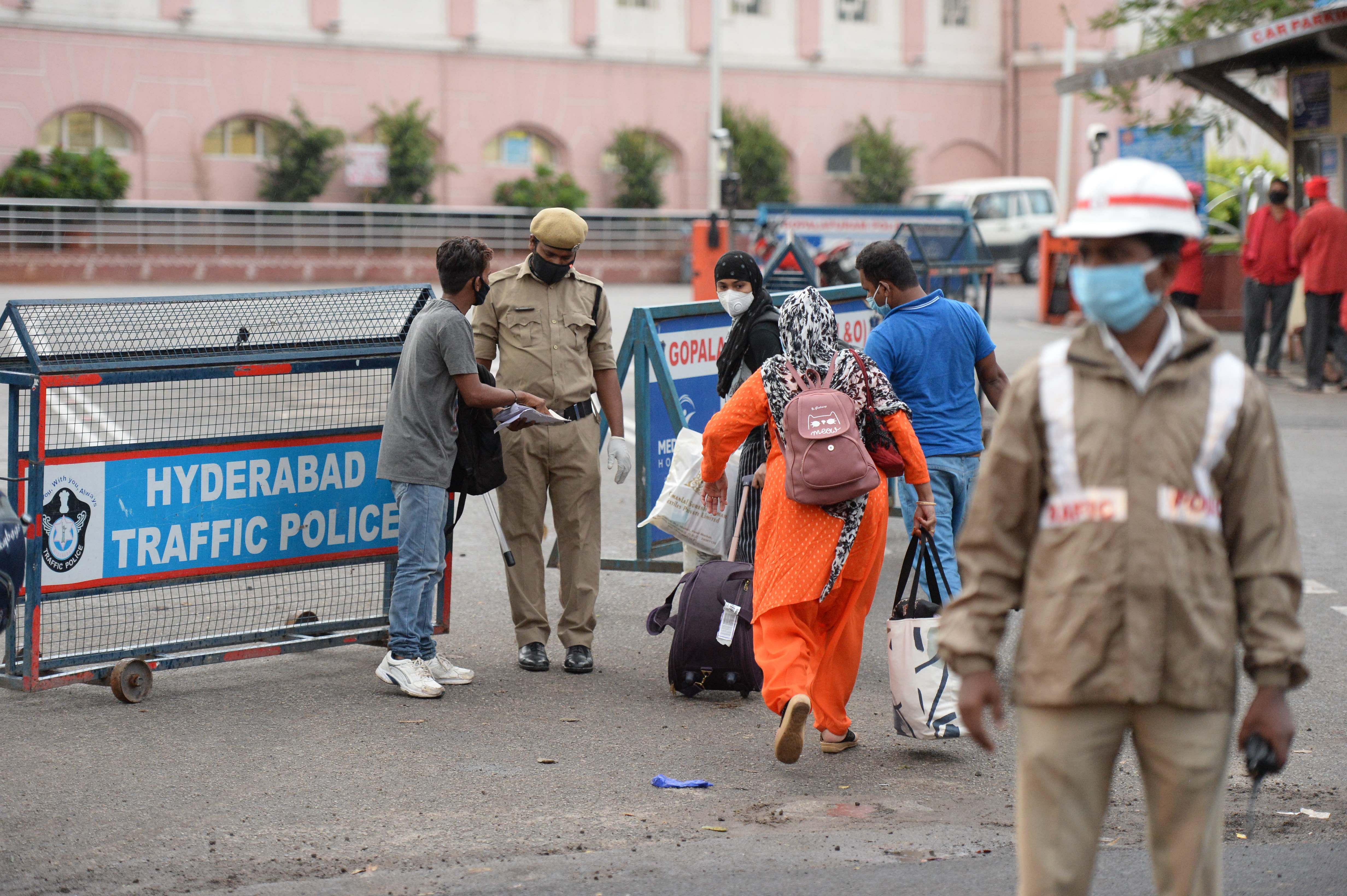 Police personnel checks passengers' reservation tickets outside a railway station in Secunderabad on June 1, 2020, as Indian Railways resumed operations of some 200 passenger trains across the country. (PTI Photo)