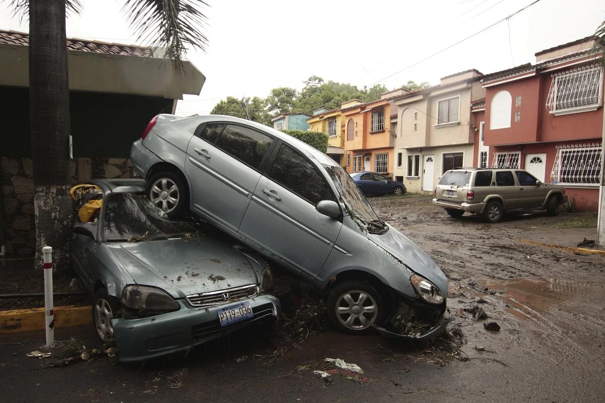: Vehicles stand damaged by an Acelhuate River flash flood at a neighborhood in San Salvador, El Salvador (AP Photo)