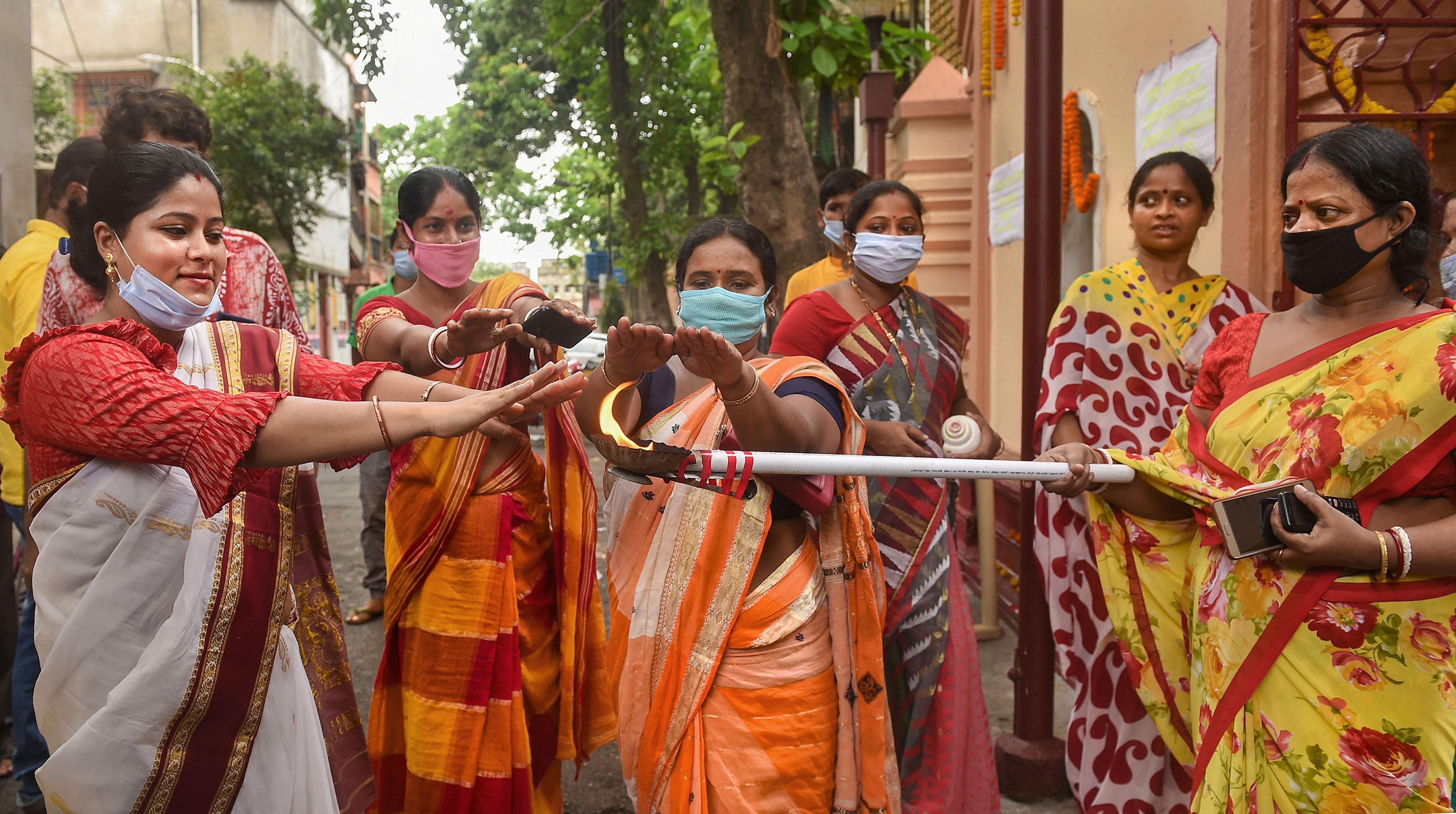 Devotees offer prayers to goddess Ganga at a temple on the occasion of Ganga Pooja, on the first day of COVID-19 lockdown 5.0, in Kolkata, Monday, June 1, 2020. (PTI Photo)