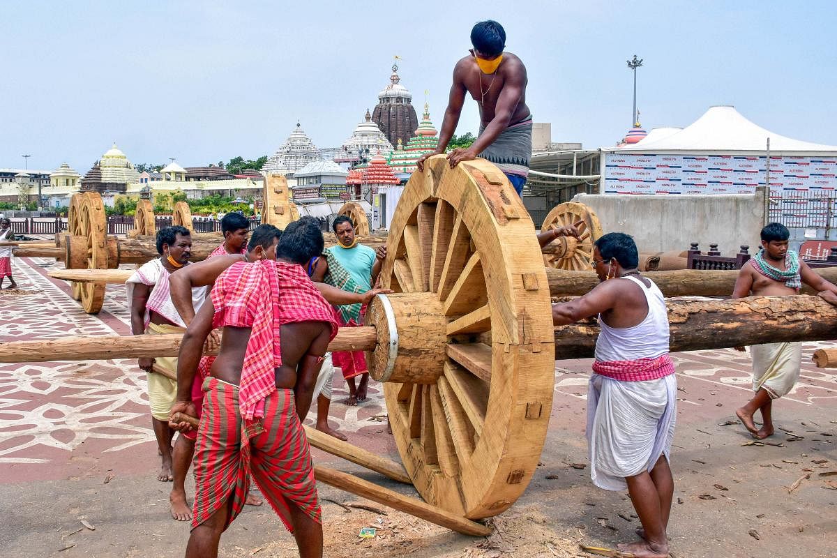 Workers construct wheels of the chariots for Lord Jagannath's Rath Yatra (PTI Photo)