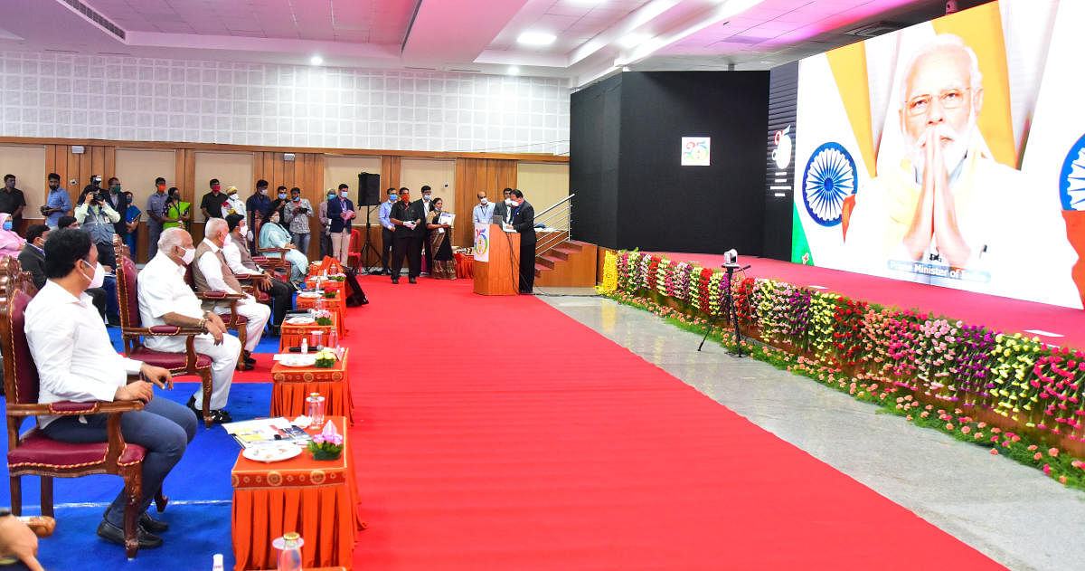 Prime Minister Narendra Modi inaugurates the silver jubilee celebrations of Rajiv Gandhi University of Health Sciences through video conferencing, in Bengaluru on Monday. Chief Minister B S Yediyurappa and Governor Vajubhai Vala are seen. DH Photo/Anup Ra