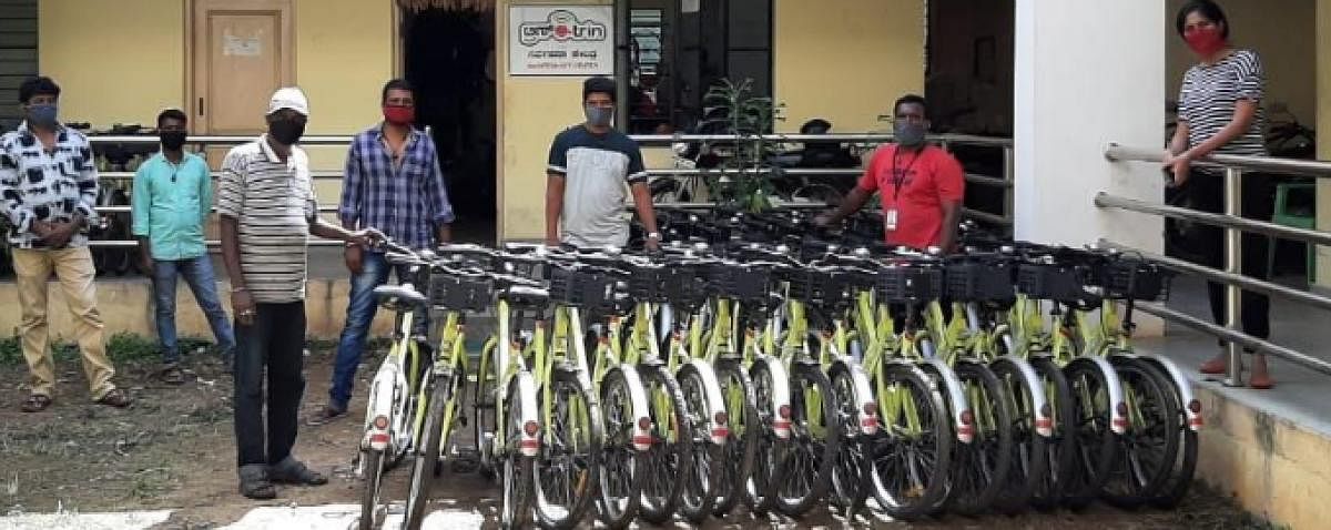 Workers shift Trin Trin bicycles to docking stations in Mysuru. Photo by special arrangement