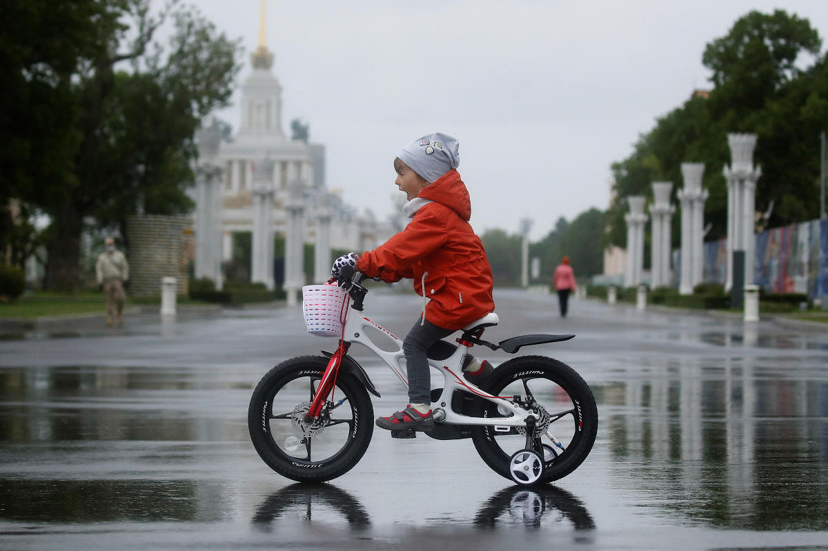 A child rides a bicycle at the Exhibition of Achievements of National Economy (VDNKh) on the first day of reopening following the easing of lockdown measures, which were introduced amid the outbreak of the coronavirus disease (COVID-19) in Moscow, Russia June 1, 2020.  Credit: Reuters