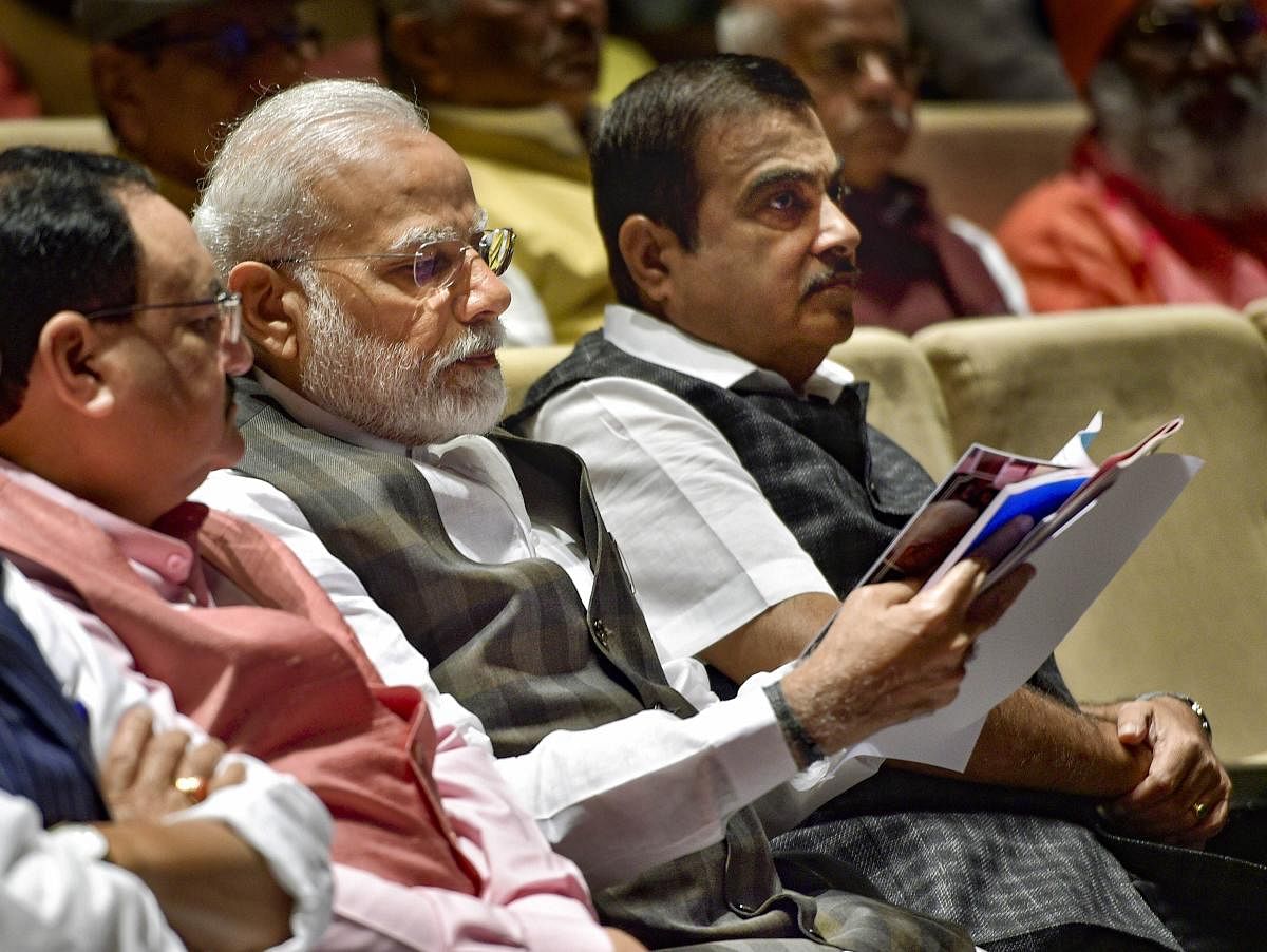 Prime Minister Narendra Modi (C), BJP National President JP Nadda (L) and Union Minister Nitin Gadkari (PTI)