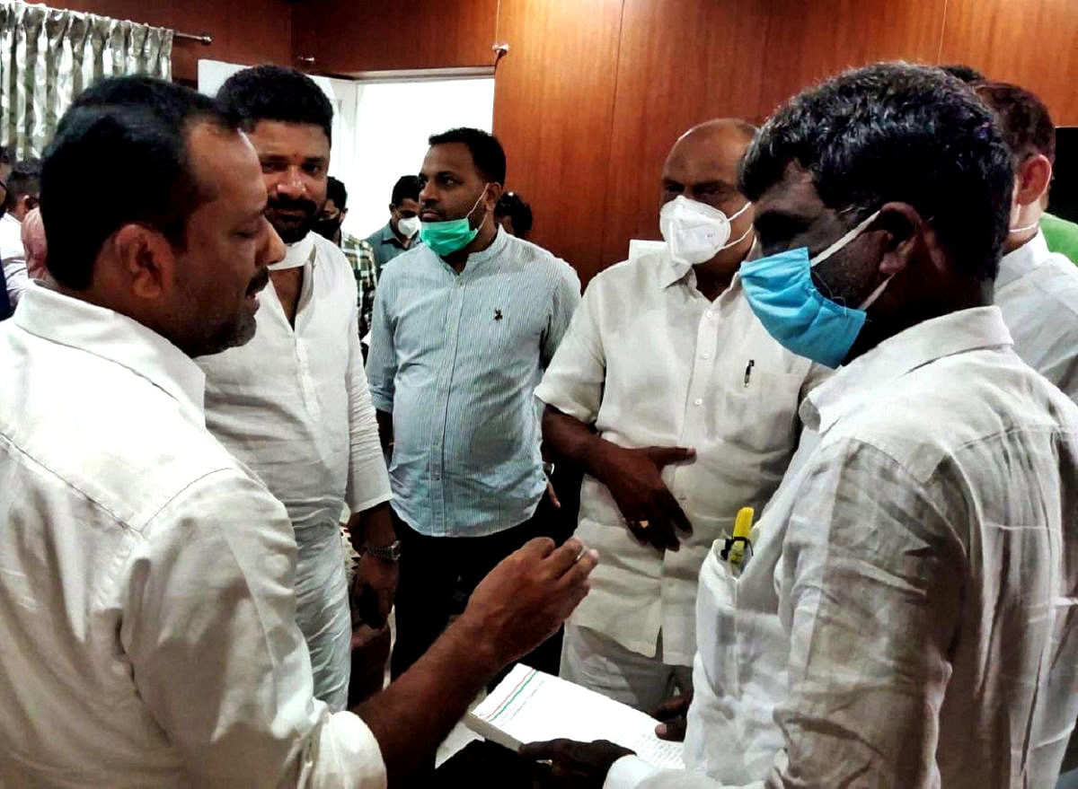 A delegation of Congress leaders speaks to District In-charge Minister Kota Srinivas Poojary after submitting a memorandum in Mangaluru on Tuesday.