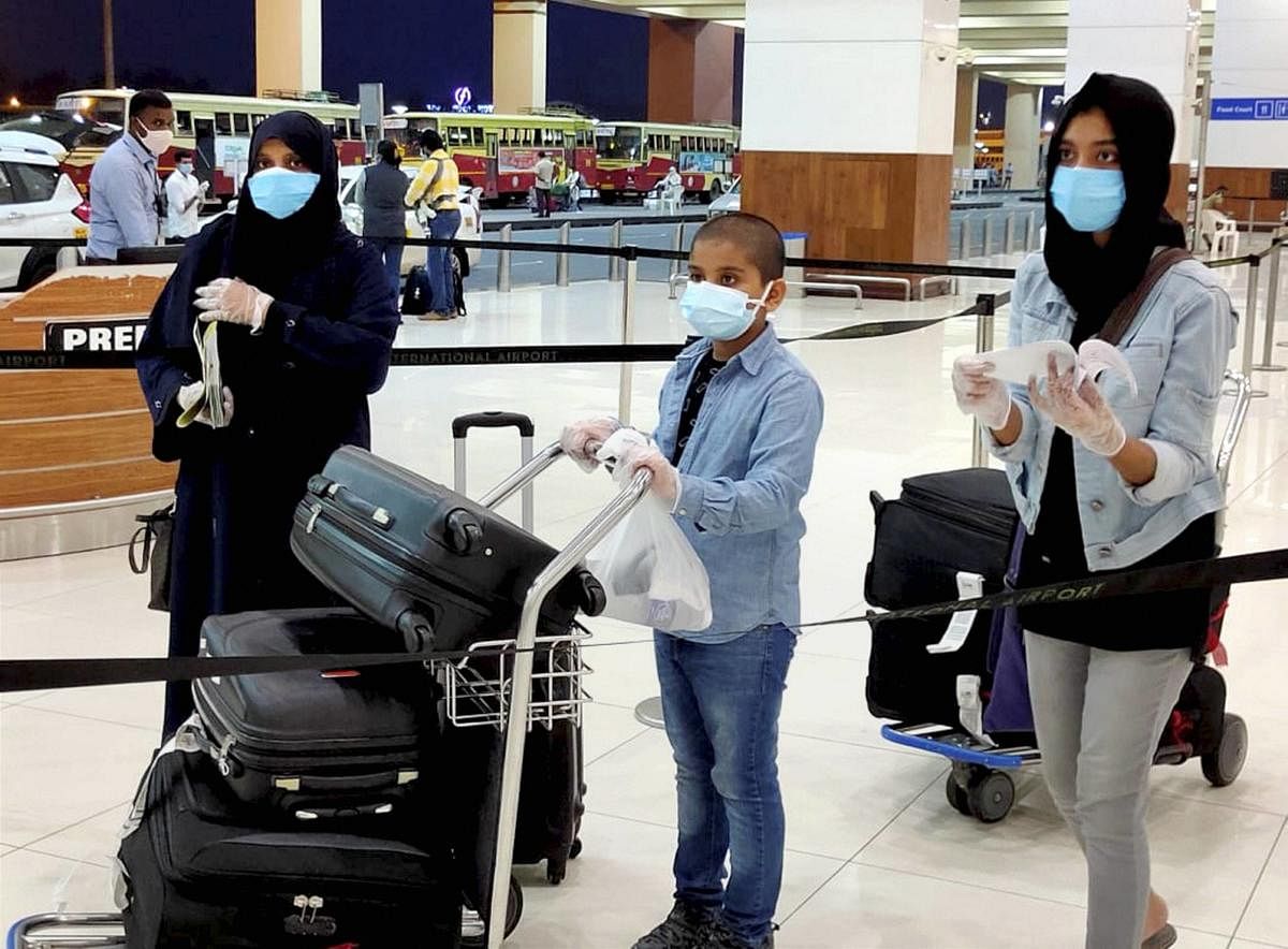 Passengers arrive from Dubai by an Air India flight at Kochi International Airport, as part of an evacuation operation due to closure of commercial air services amid the ongoing coronavirus pandemic. PTI