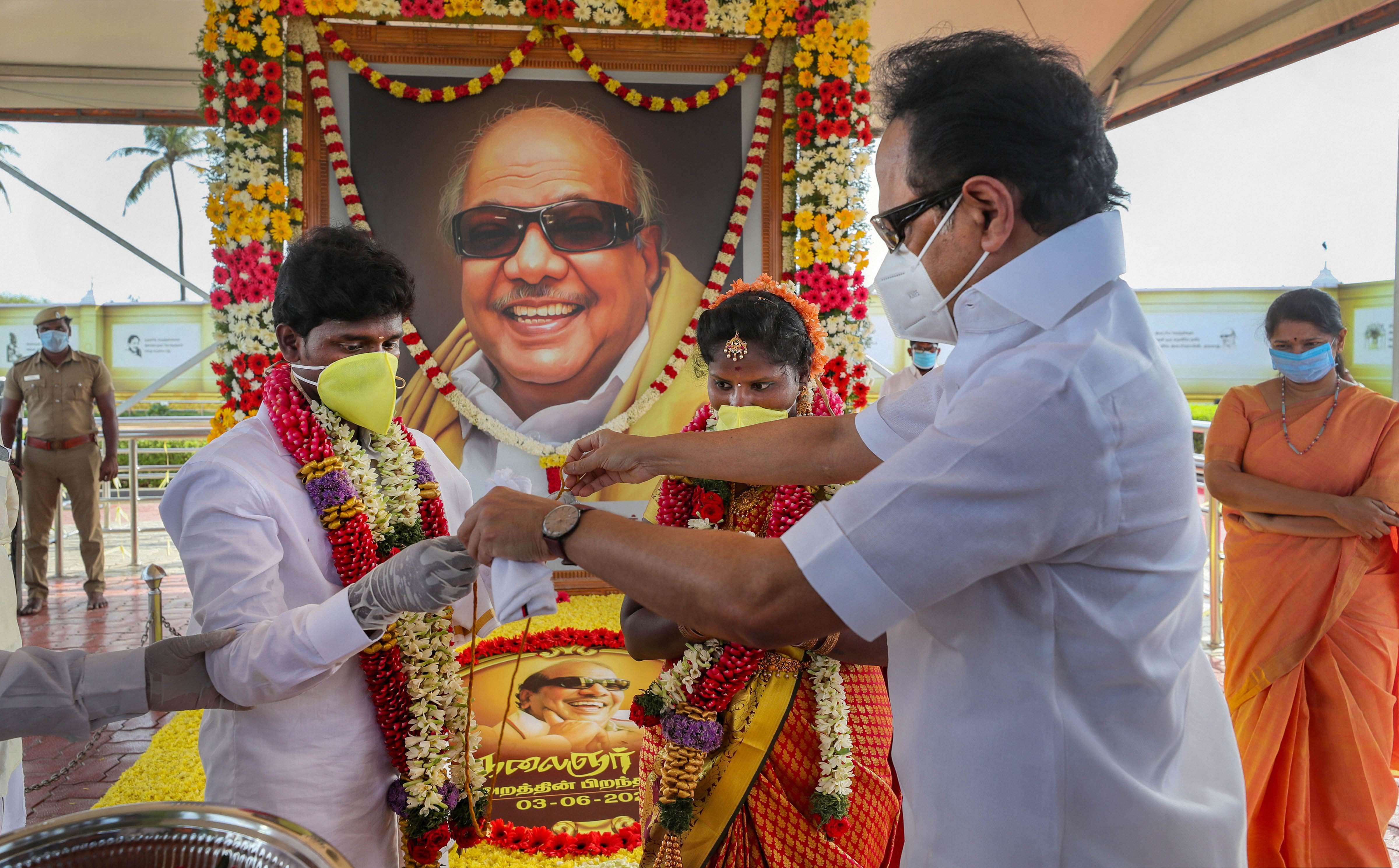 DMK President MK Stalin organises marriage of a couple on the occasion his father the late M Karunanidhi's 97th birth anniversary, at his memorial at Marina beach in Chennai, Wednesday, June 3, 2020. (PTI Photo) 