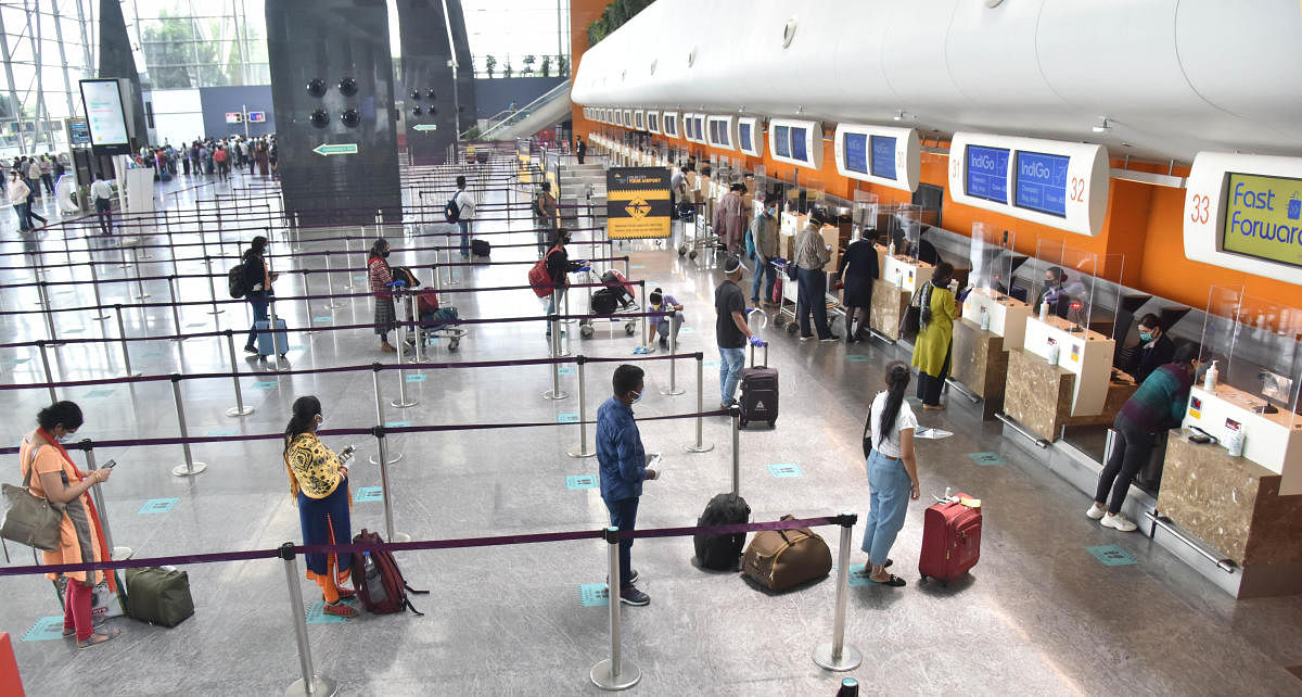 Passengers maintain social distancing while lining up at check-in counters at the Kempegowda International Airport on Tuesday. DH PHOTO/JANARDHAN B K