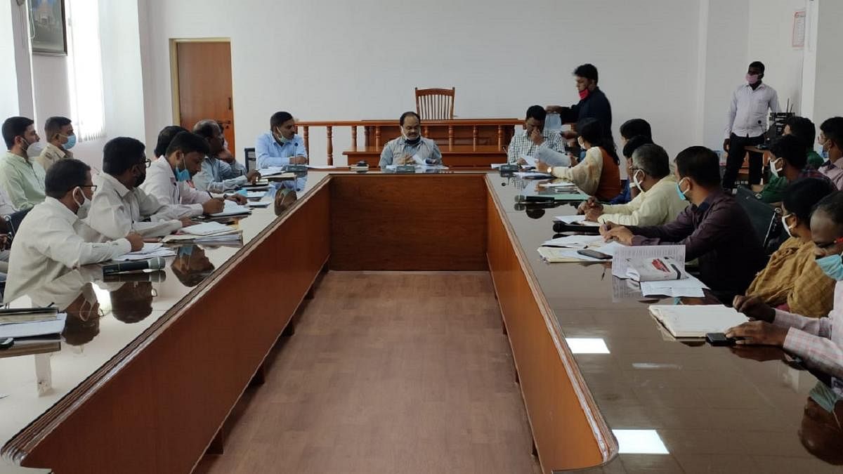 Deputy Commissioner M R Ravi and officials during a meeting in Chamarajangar on Tuesday. DH PHOTO