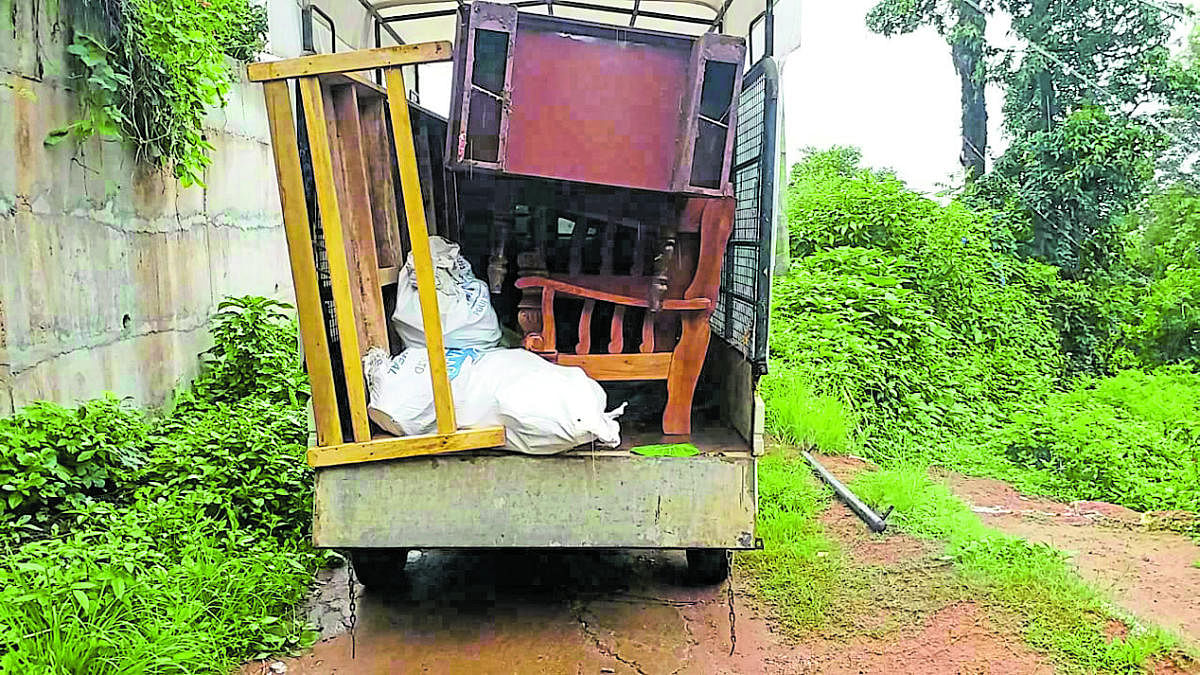 A resident transports furniture while shifting to a rented house fearing heavy rain, in Madikeri.