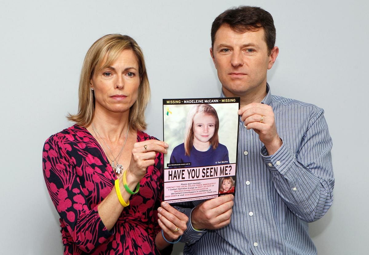  Kate and Gerry McCann pose with a computer generated image of how their missing daughter Madeleine might look now, during a news conference in London. Credit/Reuters Photo