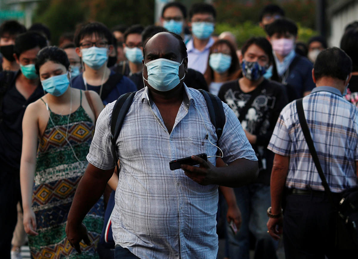 People cross a street during morning peak hour commute amid the coronavirus disease (COVID-19) outbreak in Singapore June 3, 2020. Credit: Reuters Photo