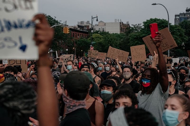 Demonstrators denouncing systemic racism in law enforcement march through the borough of Brooklyn minutes before a citywide curfew went into effect. (Reuters Photo)