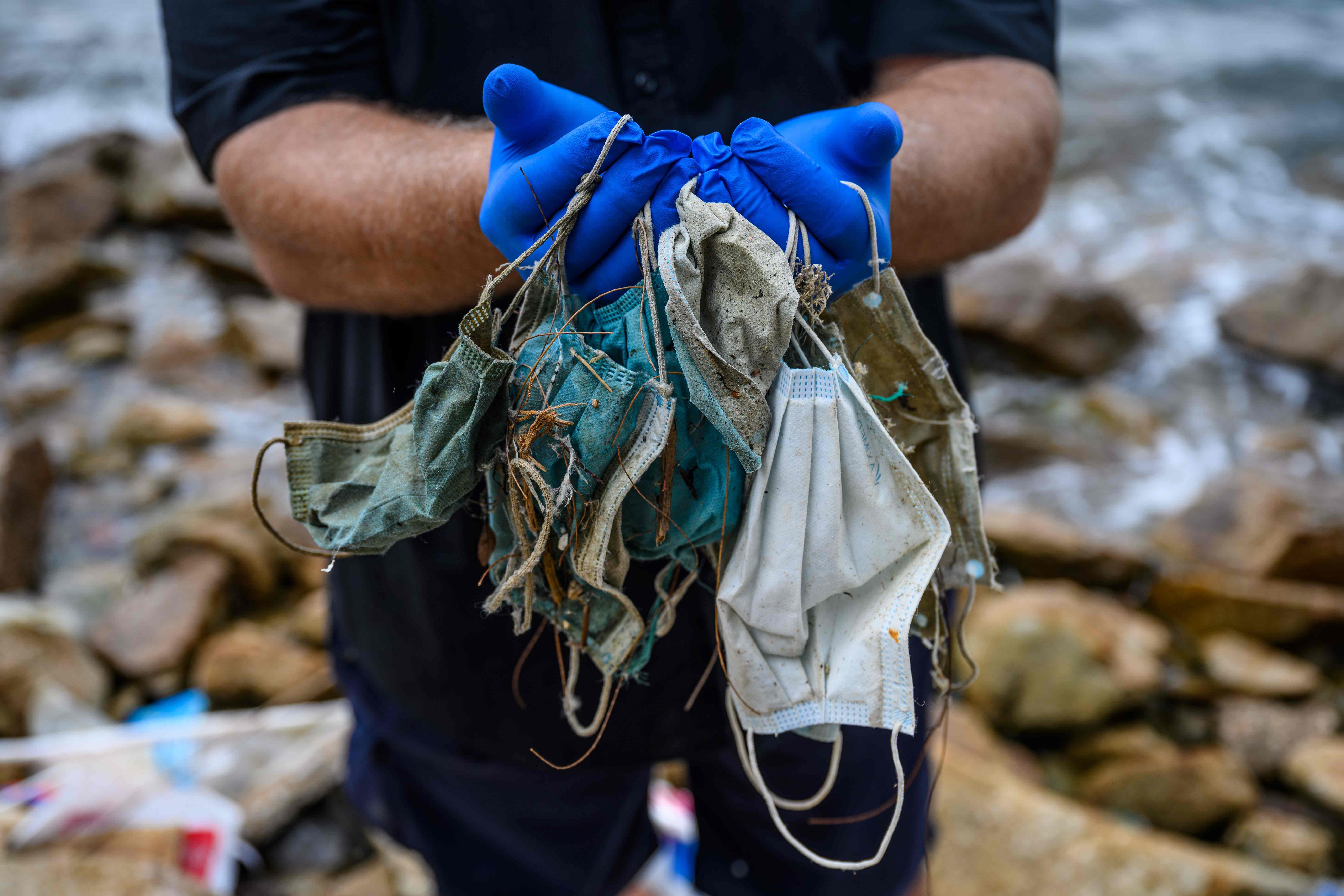 Surgical masks are washing up in growing quantities on the shores of Hong Kong. Credit: AFP Photo