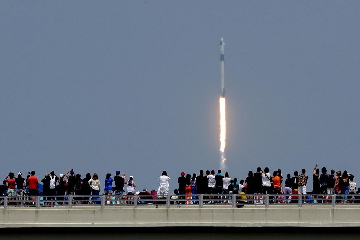 Titusville: Spectators watch from a bridge in Titusville, Fla., as SpaceX Falcon 9 lifts off with NASA astronauts Doug Hurley and Bob Behnken in the Dragon crew capsule, Saturday, May 30, 2020, from the Kennedy Space Center at Cape Canaveral, Fla. The two