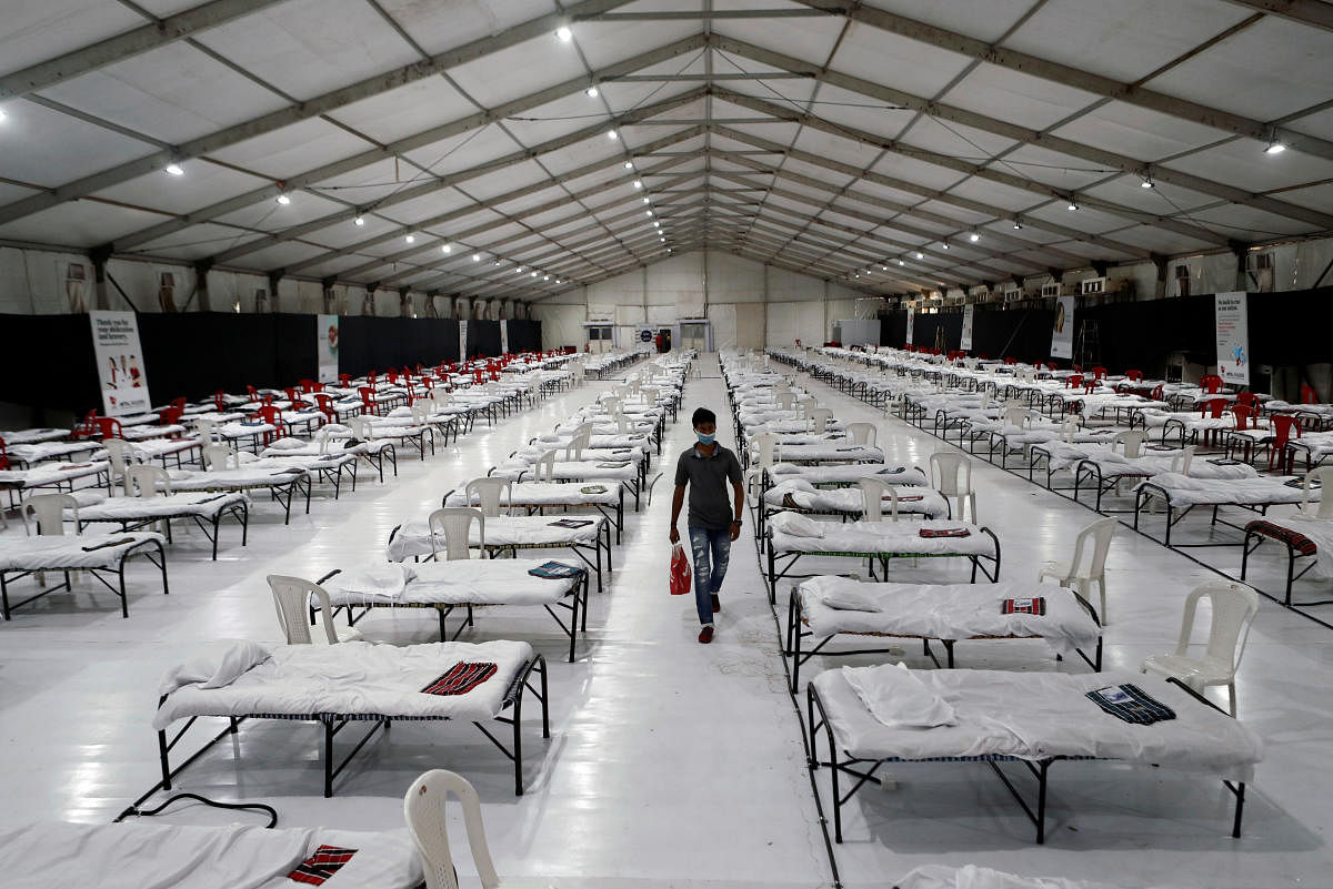 A man walks inside a hospital that has been constructed to treat patients who test positive for the coronavirus disease, in Mumbai. Reuters