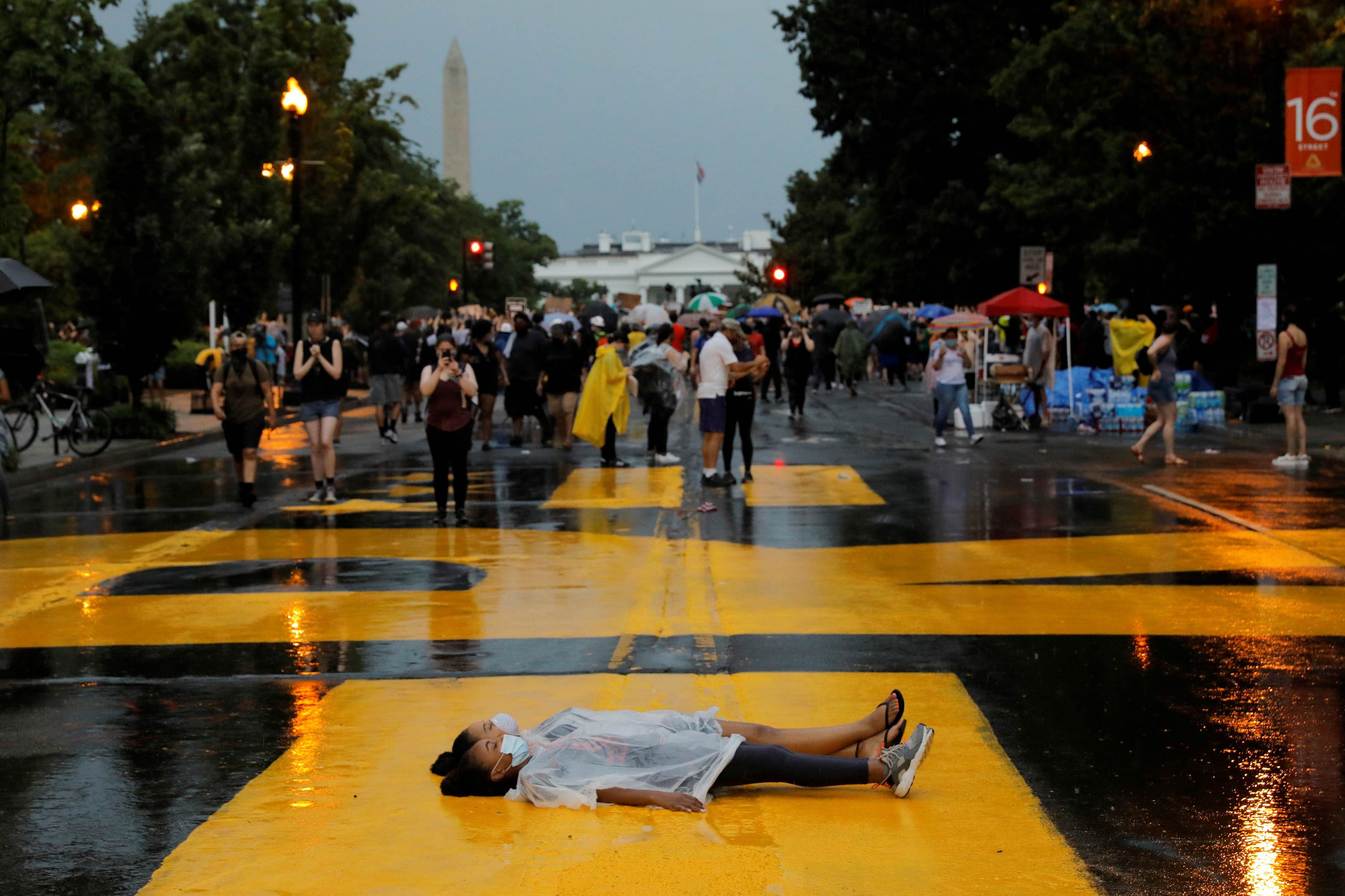 Rukiya Ahmed and Yoreanos Alemu lie on the street as a protest against the death in Minneapolis police custody of George Floyd, in Washington. Credit: Reuters Photo