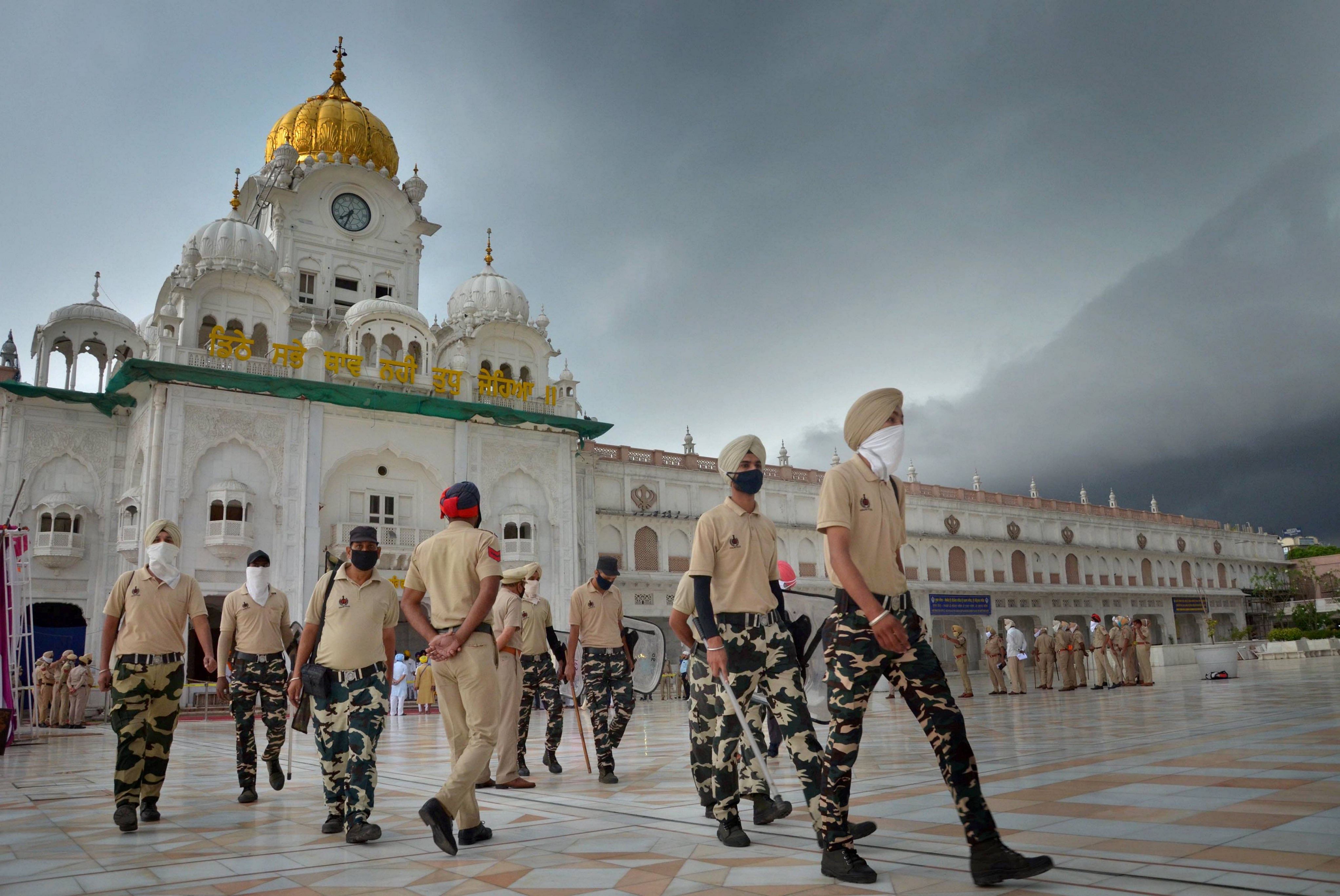 Anti Riot Police (ARP) personnel stand guard outside the main entrance of Golden Temple on the occasion of the 36th anniversary of Operation Blue Star. Credit: PTI Photo