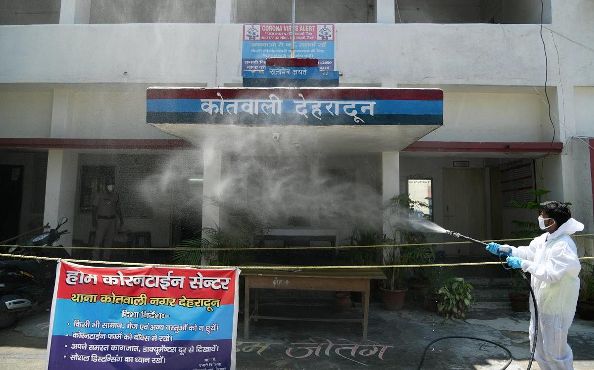 An MCD worker sprays disinfectant outside a quarantine centre at Kotwali, during the ongoing COVID-19 lockdown, in Dehradun, Saturday, June 6, 2020. (PTI Photo)