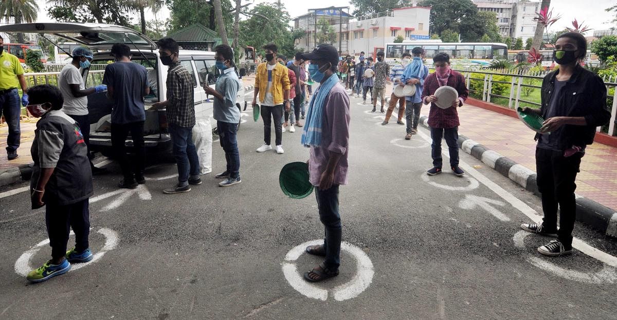  Migrants wait in queues to receive rice being distributed by the Kamrup administration outside the Guwahati Railway Station during ongoing COVID-19 lockdown, in Guwahti, Wednesday, June 3, 2020. (PTI Photo)