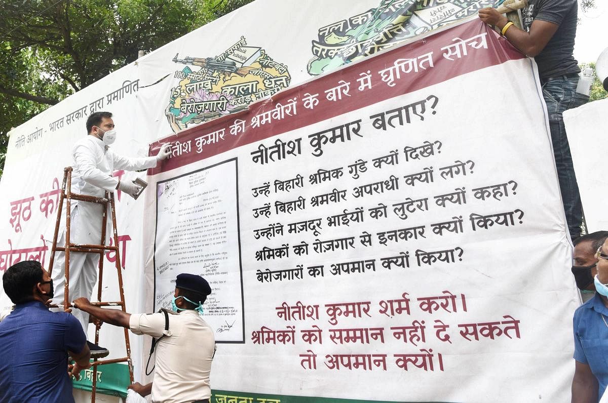  RJD leader Tejashwi Yadav put a poster outside party office against the state government, during the ongoing COVID-19 lockdown, in Patna, Saturday, June 6, 2020. Credit/PTI Photo