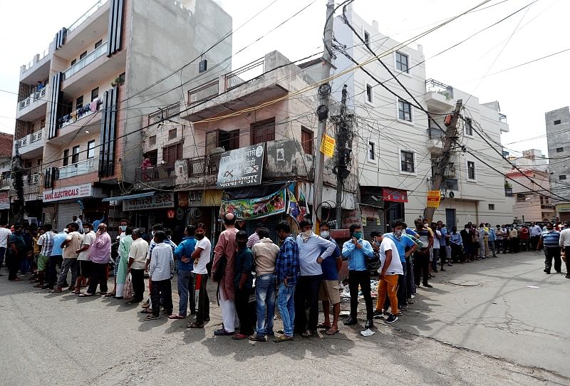 eople stand in a queue to buy liquor outside a wine shop during an extended nationwide lockdown to slow the spread of COVID-19, in New Delhi. Credit: Reuters Photo