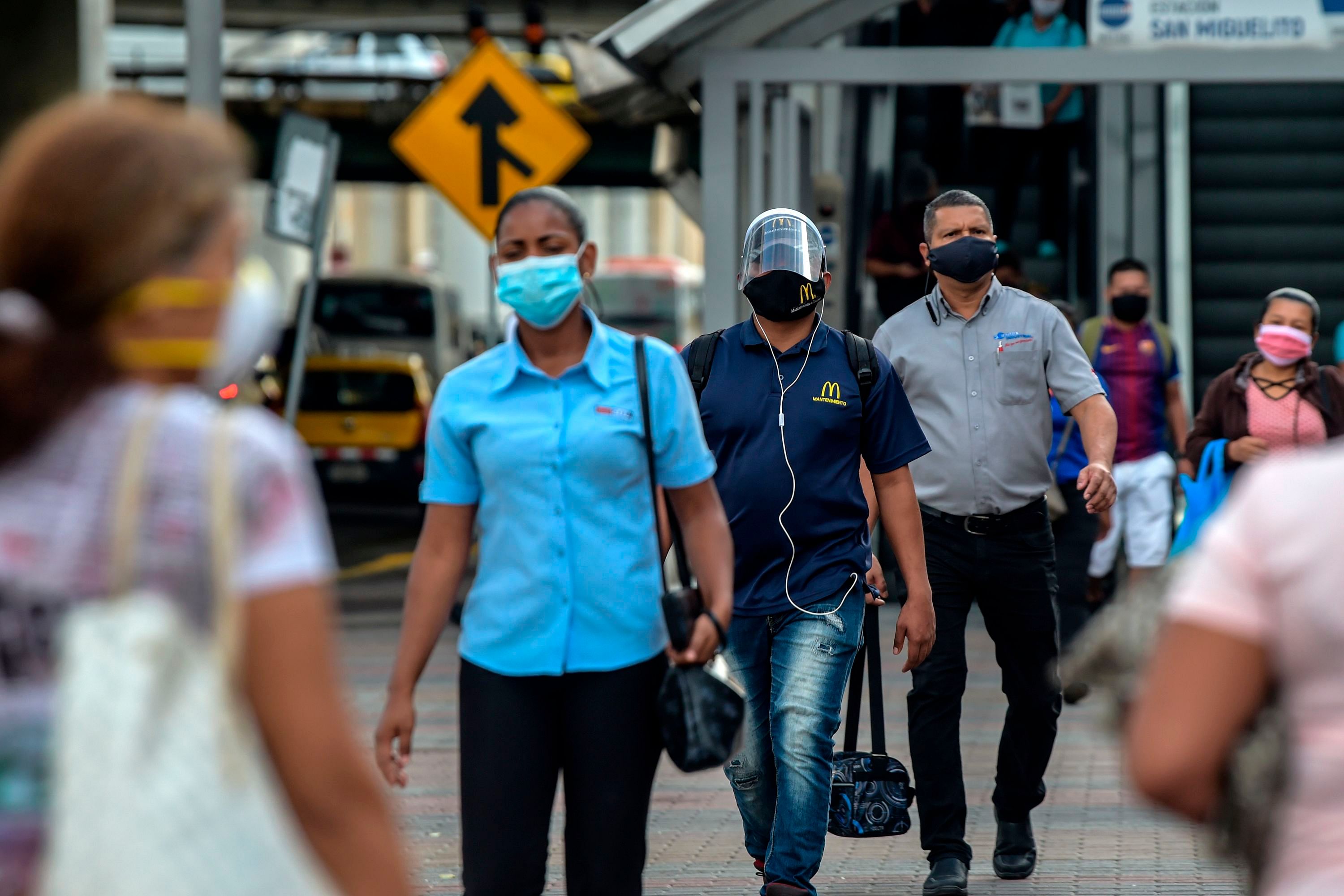 People wear face masks amid concern over the spread of the COVID-19 coronavirus, in Panama City. (AFP Photo)