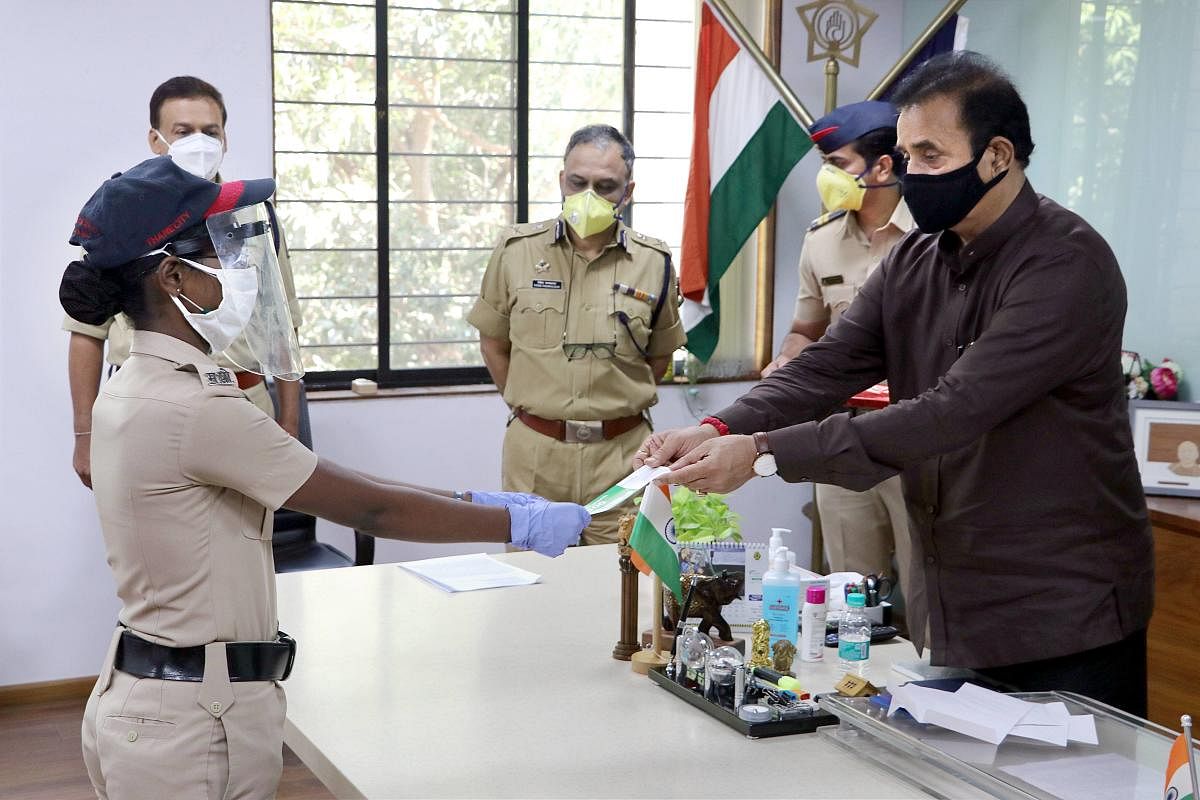 Maharashtra Home Minister Anil Deshmukh felicitates a woman cop in Thane. PTI/File photo