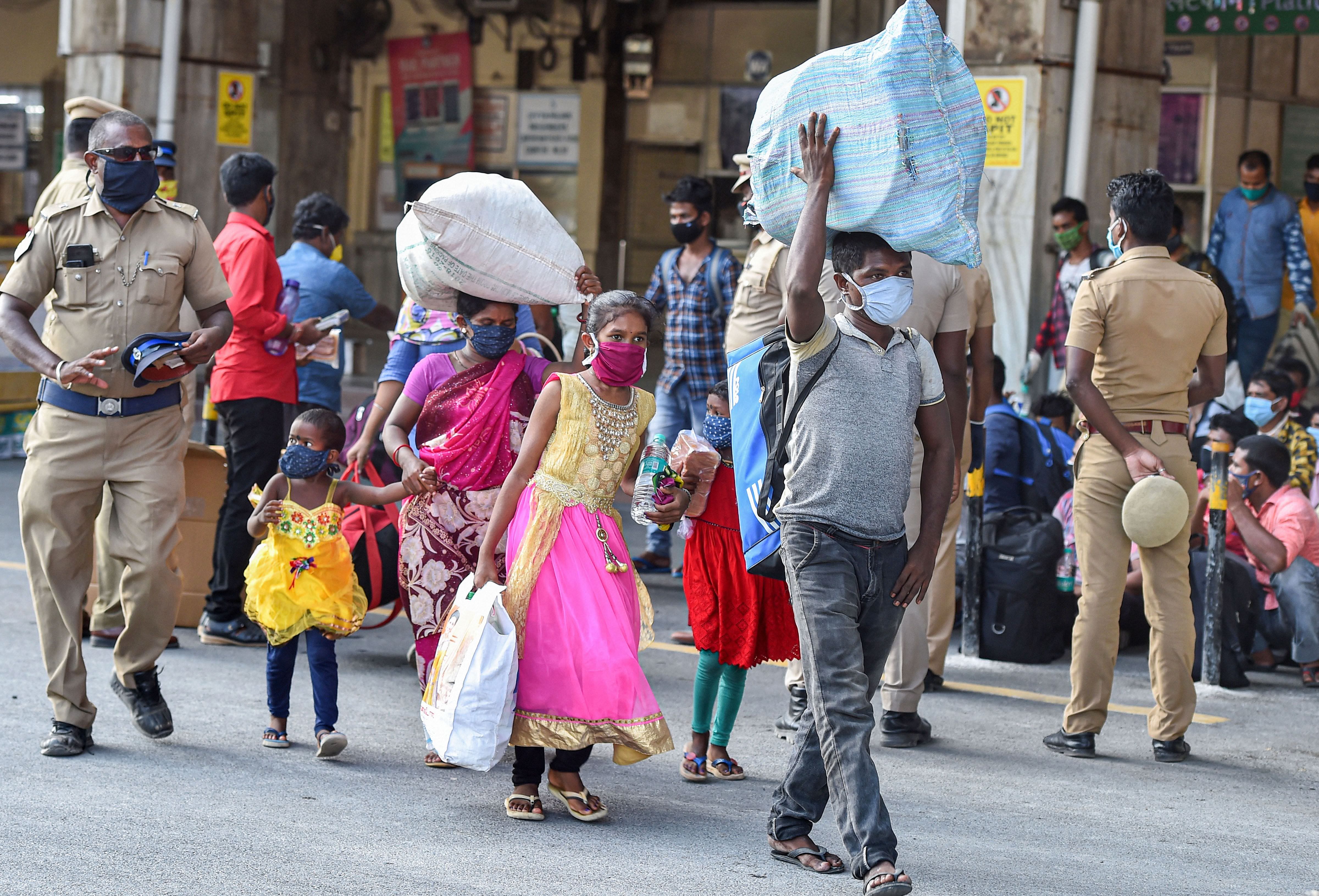 Migrants arrive at Central Railway Station to board a Shramik Special train for West Bengal, during ongoing COVID-19 lockdown, in Chennai. Credit: PTI Photo