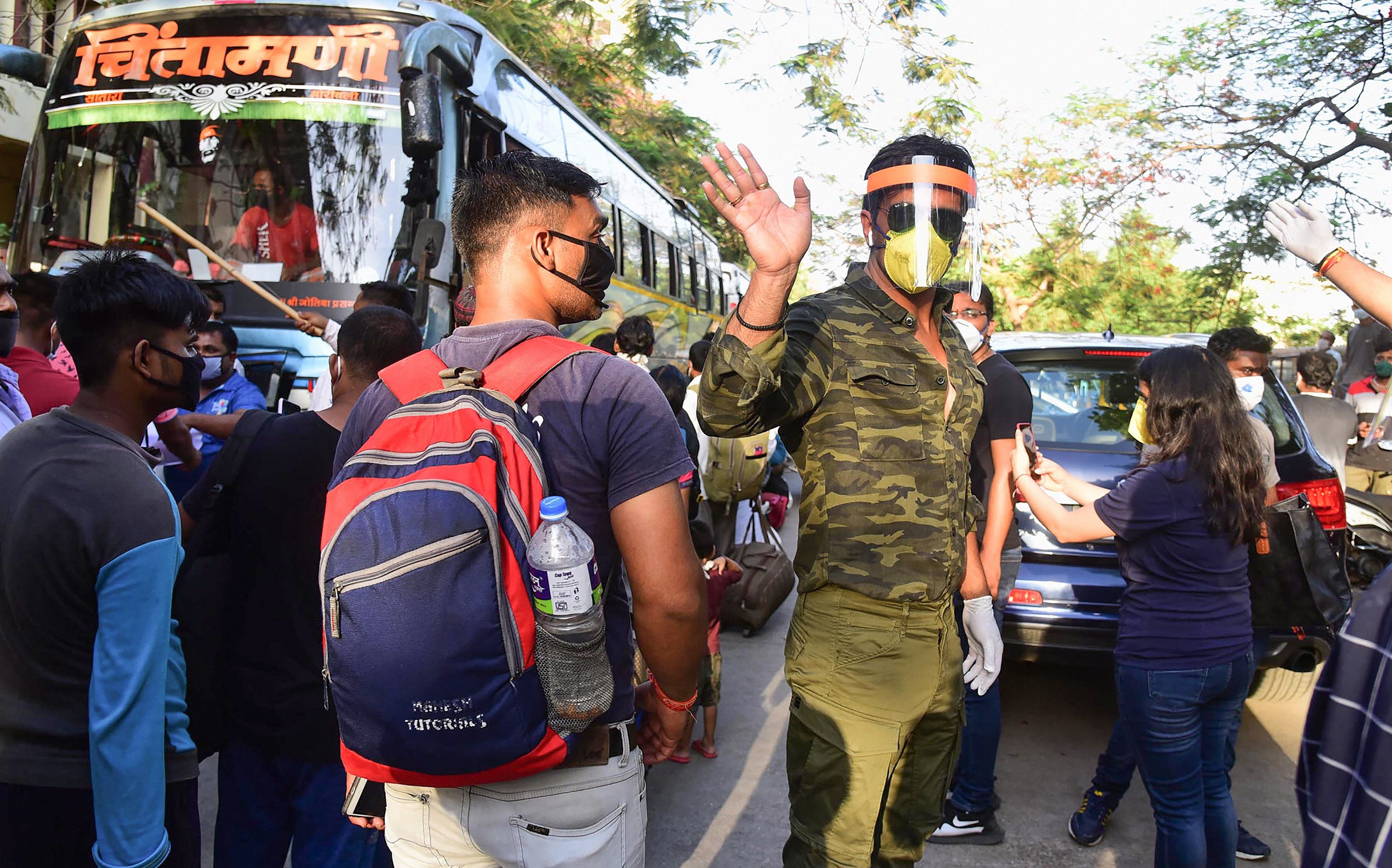 Bollywood actor Sonu Sood while sending off migrants to their native places by buses, amid COVID-19 lockdown at Wadala TT police station in Mumbai, Saturday, May 23, 2020. (PTI Photo)