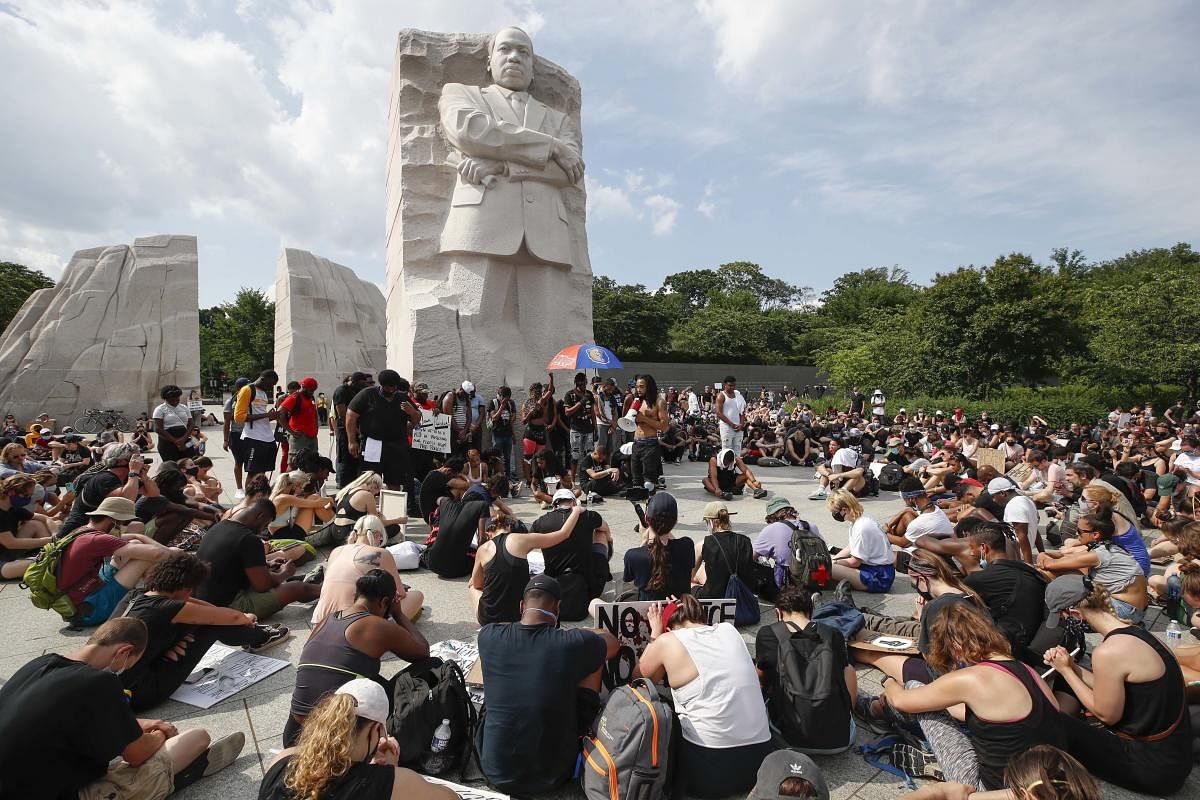 Demonstrators protest Saturday, June 6, 2020, at the Martin Luther King Jr. Memorial in Washington, over the death of George Floyd, a black man who was in police custody in Minneapolis. AP/PTI