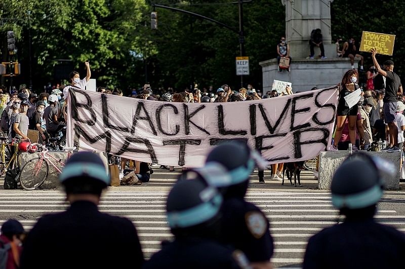 Demonstrators hold a Black Lives Matter banner during a protest against racial inequality in the aftermath of the death in Minneapolis police custody of George Floyd. Credit: Reuters Photo
