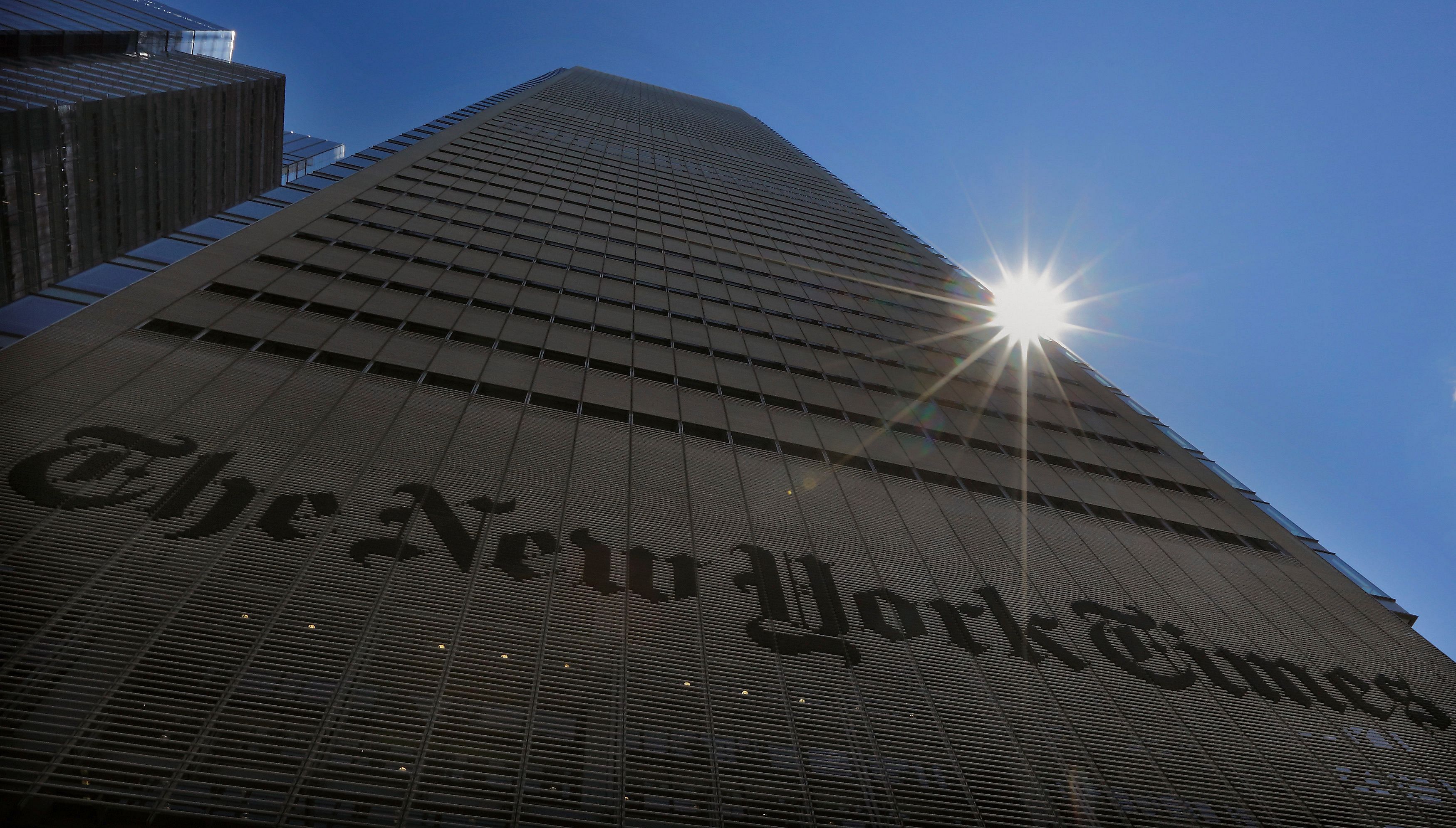The sun peaks over the New York Times Building in New York. Credit: Reuters