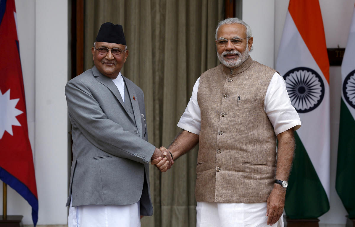 Nepal's Prime Minister Khadga Prasad Sharma Oli (L) shakes hands with his Indian counterpart Narendra Modi during a photo opportunity ahead of their meeting at Hyderabad House in New Delhi, India, February 20, 2016. (REUTERS)