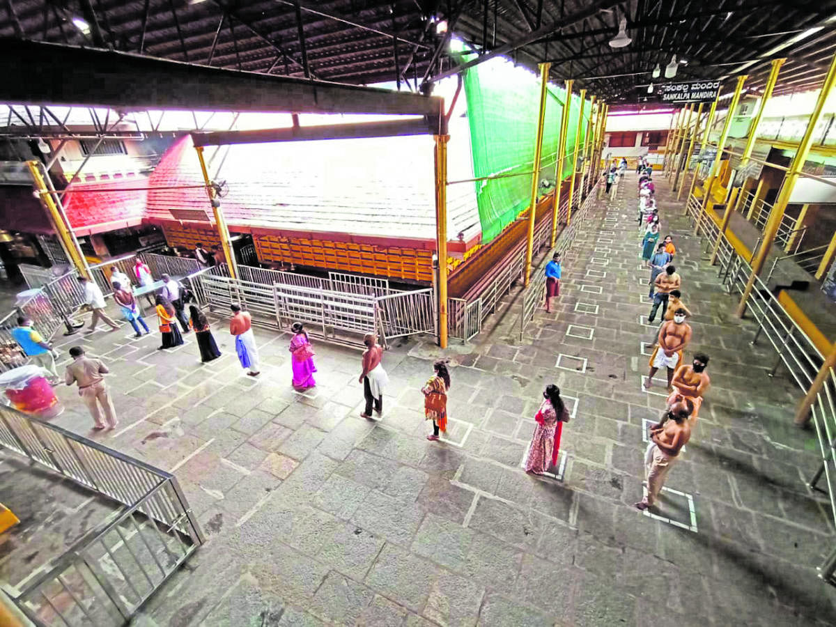 Devotees stand in squares marked to maintain social distancing at Kukke Subrahmanya Temple on Monday.