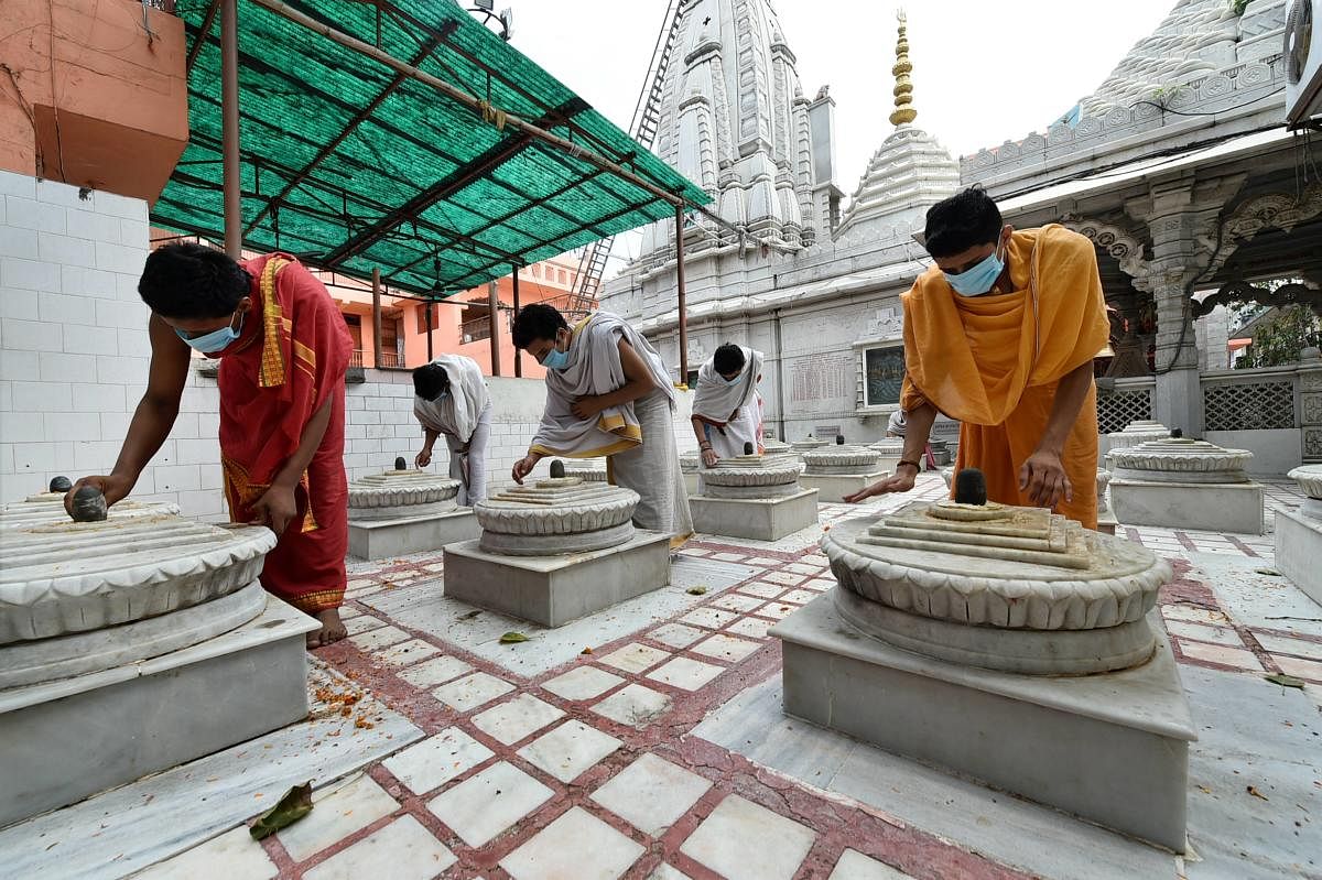 Monks prepare for the opening of Dudeshwaranath Mahadev Math for devotees, after COVID-19 lockdown restriction were eased (PTI Photo)