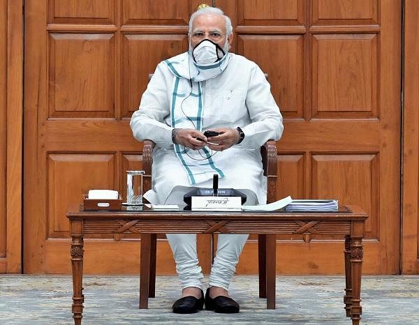 Prime Minister Narendra Modi wearing a face mask chairs a cabinet meeting in New Delhi. (PTI Photo)