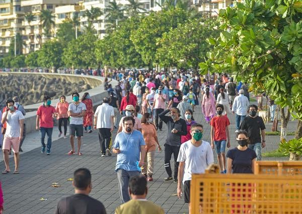 People walk along the sea-facing promenade at Marine Drive, during the first phase of unlocking the ongoing COVID-19 nationwide lockdown, in Mumbai, Sunday, June 7, 2020. Credit: PTI Photo/Mitesh Bhuvad