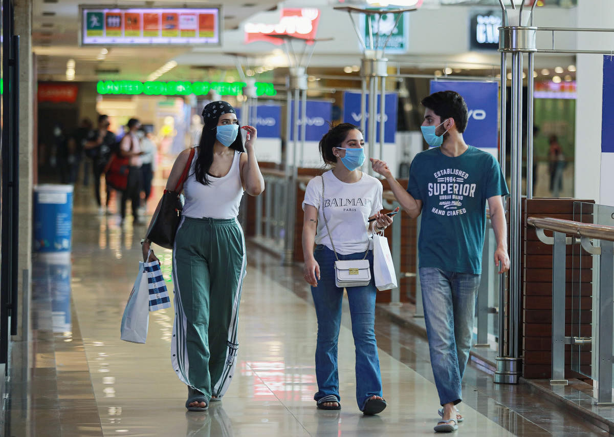 People wearing masks walk with shopping bags inside a mall as India eases lockdown restrictions that were imposed to slow the spread of the coronavirus disease (COVID-19), in New Delhi, India, June 8, 2020. Credit: REUTERS Photo