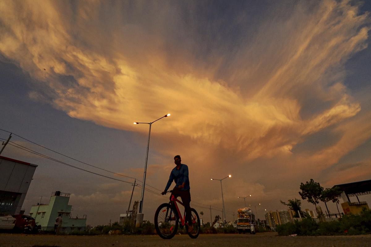 A man riding a bicycle is silhoutted during sunset, amid the ongoing COVID-19 lockdown (PTI Photo)