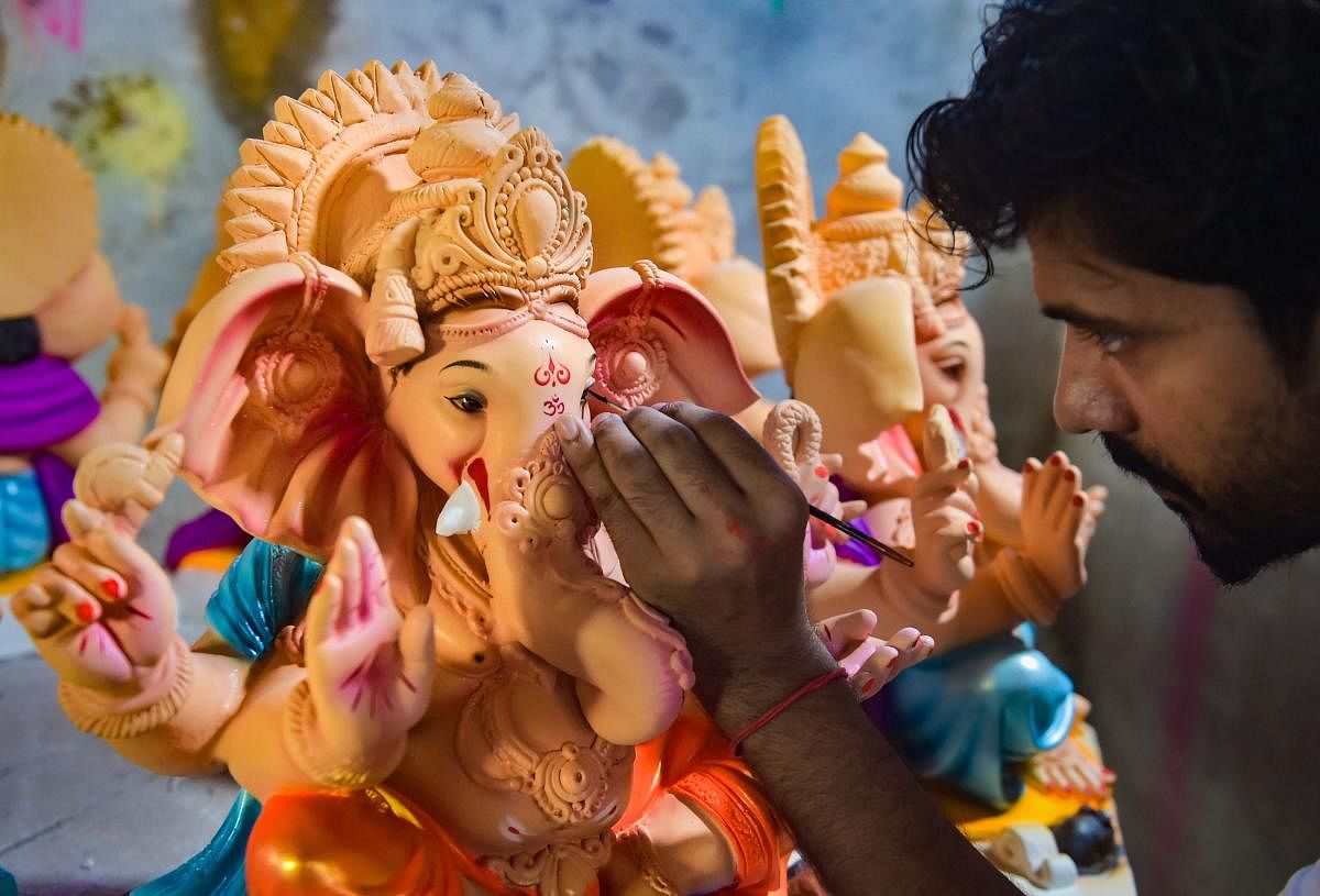 An artist gives final touches to an idol of Lord Ganesh at a unit at Hamrapur village in Pen Taluka of Raigad district, Monday, May 25, 2020. (PTI)