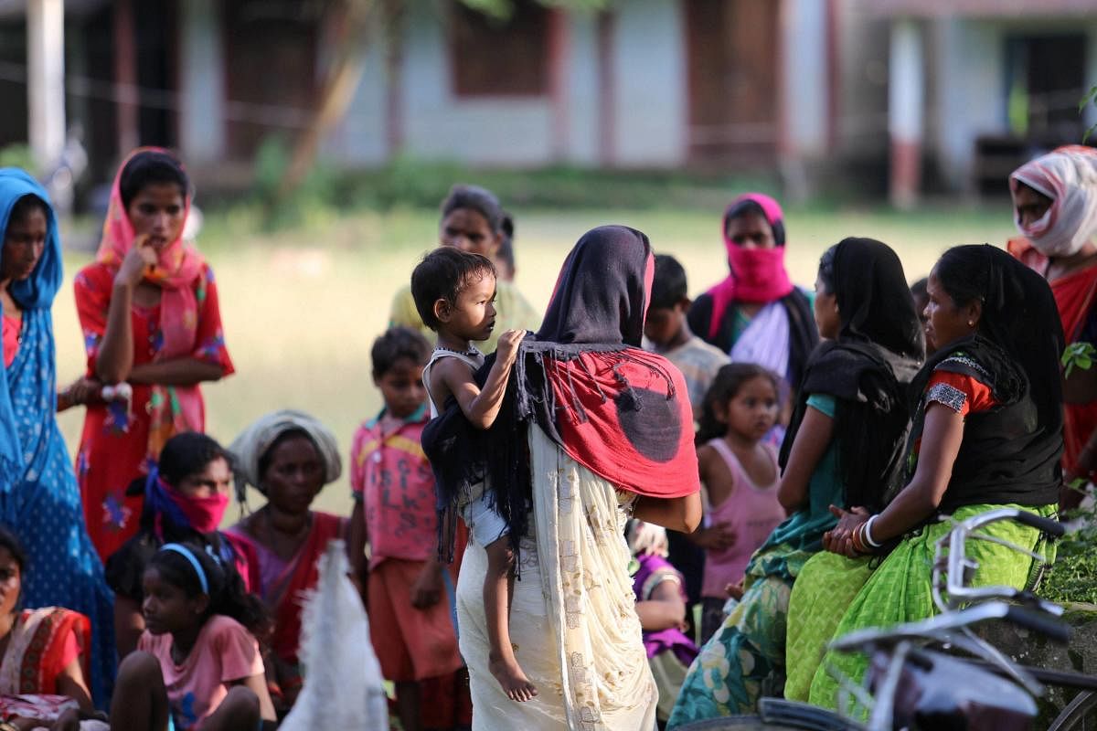 Locals being shifted to a rescue camp by Oil India in Assam (PTI Photo)