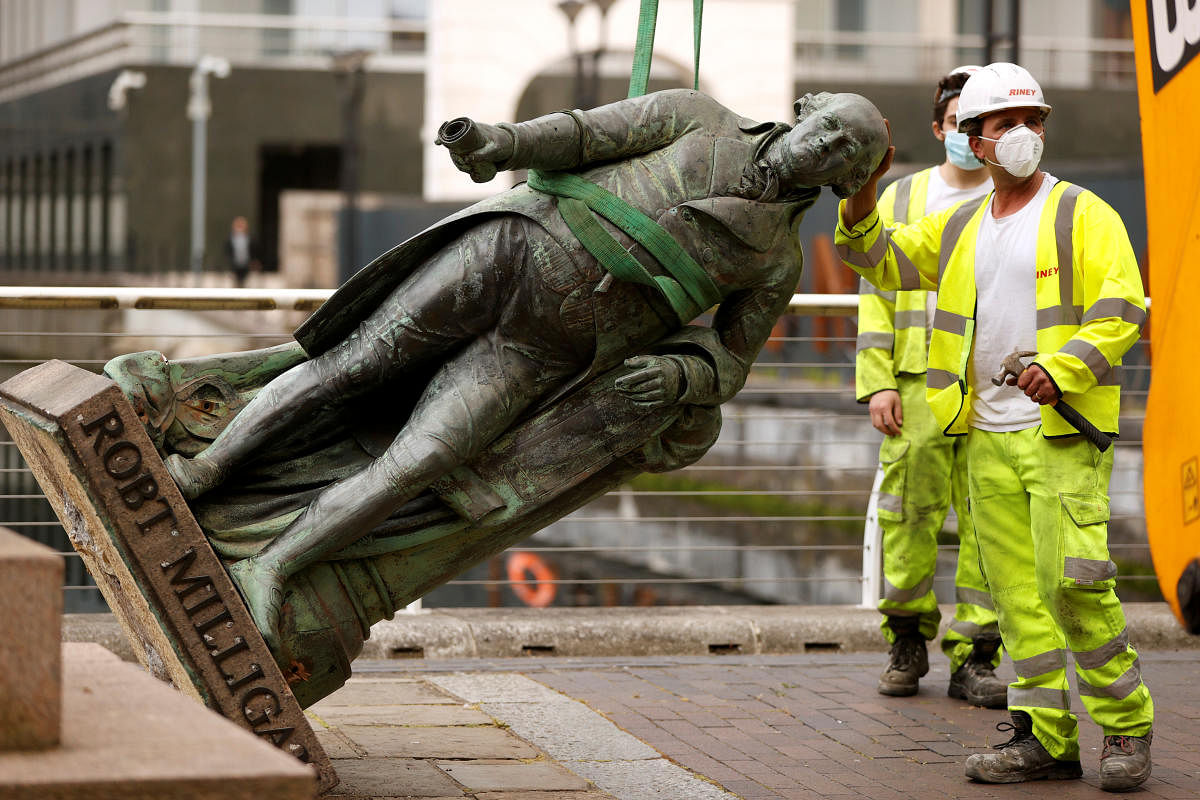 A statue of Robert Milligan is pictured being removed by workers (Reuters Photo)