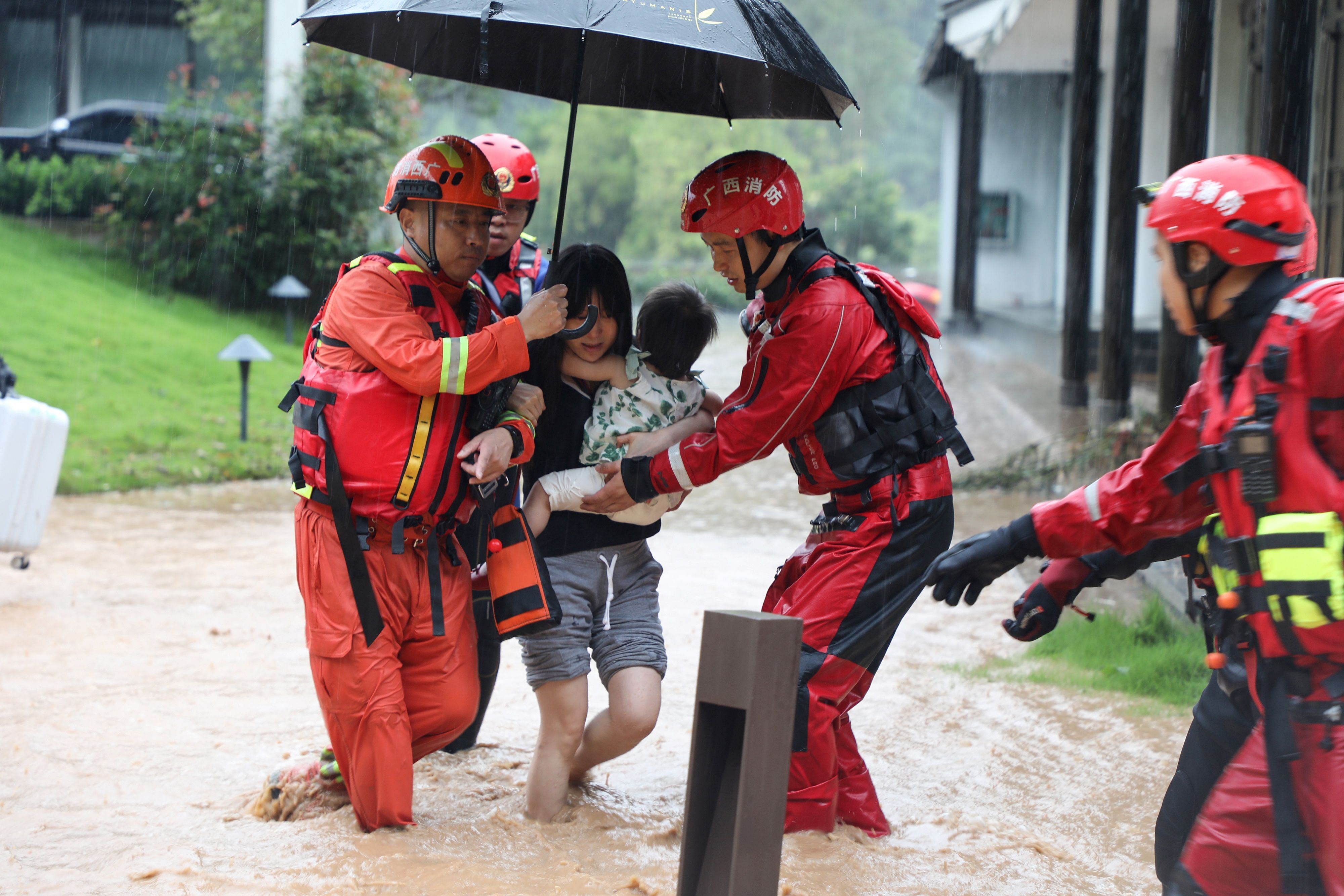 rescuers evacuating people in a flooded area after heavy rain in Yangshuo, in China's southern Guangxi region. Credits: AFP Photo